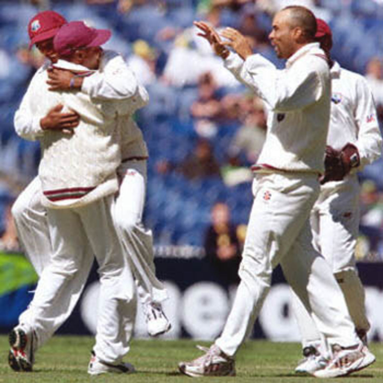 West Indies Darren Ganga (L) celebrates a catch of Australian batsman Justin Langer with teammates Brian Lara (2/L) and Jimmy Adams (R) on the third day of the fourth Test Match at the MCG in Melbourne, 28 December 2000. Australia in their second innings is 165-3 at tea for a daunting 364 run lead.