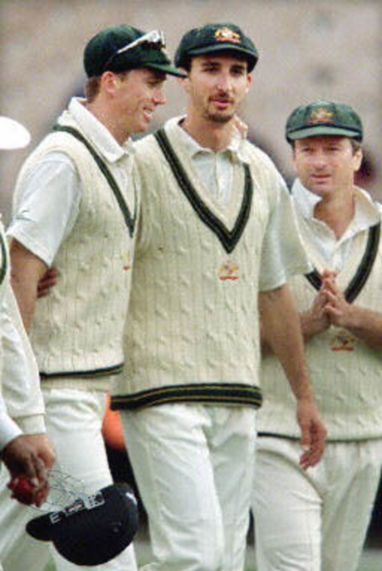 Australian paceman Jason Gillespie (C) is congratulated by fellow paceman Glenn McGrath (L) and captain Steve Waugh (R) after capturing three quick West Indian wicket late on the third day of the fourth Test Match at the MCG in Melbourne 28 December 2000. Australia declared their second innings close at 262-5 and at stumps the West Indies are again in deep trouble at 10-3 chasing 462 to win.