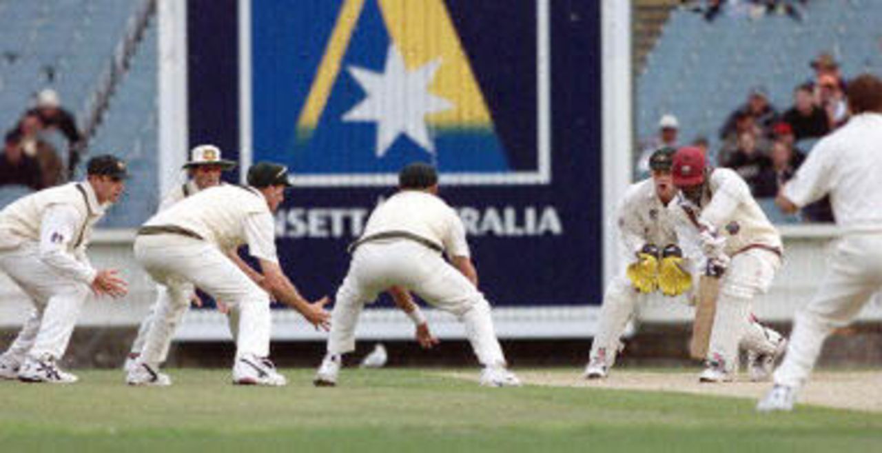 West Indian batsman Colin Stuart (2/R) is surrounded by close-in Australian fielders after the West Indies lost three quick wickets late on the third day of the fourth Test Match at the MCG in Melbourne, 28 December 2000. Australia declared their second innings close at 262-5 and at stumps the West Indies are again in deep trouble at 10-3 chasing 462 to win.