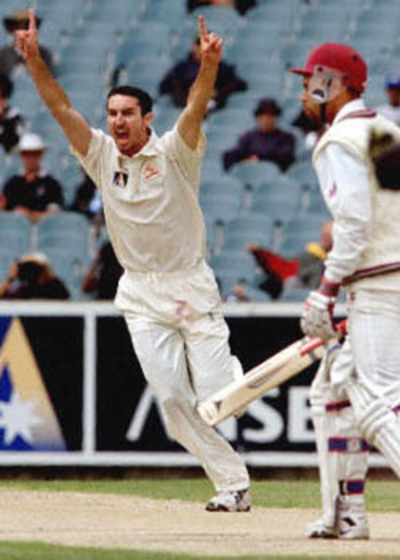 Australian paceman Jason Gillespie (L) celebrates taking the wicket of West Indian captain Jimmy Adams (R) for a golden duck as Gillespie has the figures of 6-24 on the fourth day of the fourth Test match at the MCG in Melbourne, 29 December 2000. Once again the West Indies are on the verge of defeat being 78-8 at lunch, still requiring 384 runs for victory.