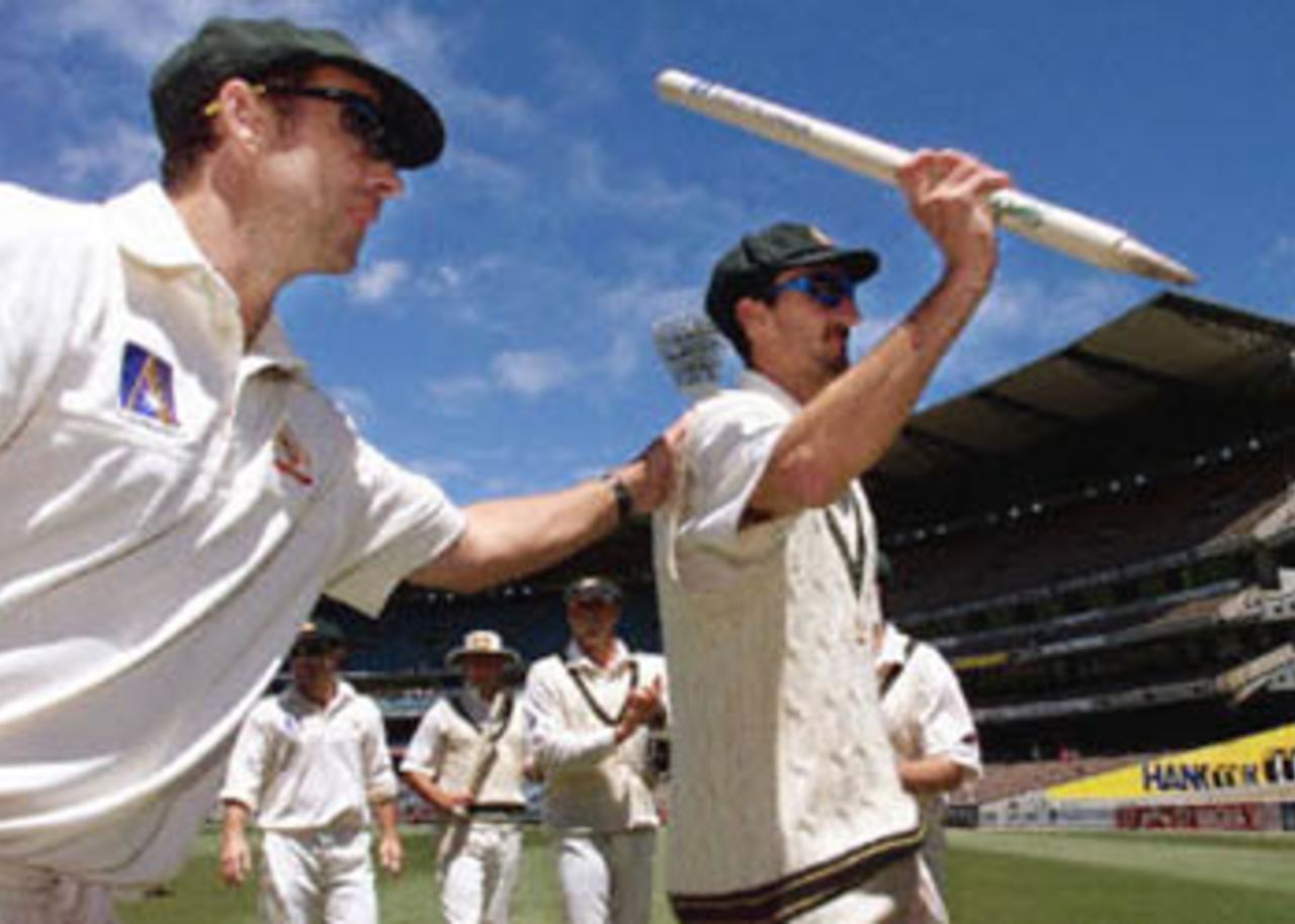 Australian paceman Jason Gillespie (R) acknowledges the applause from the crowd as teammate Colin Miller (L) gives him a pat on the back after Australian defeated the West Indies on the fourth day of the fourth Test Match at the MCG in Melbourne, 29 December 2000. Australia won the match by 352 run with Gillespie demolishing the West Indies taking 6-40. Australia lead the series 4-0 and extend their world record winning run to fourteen consecutive victories.