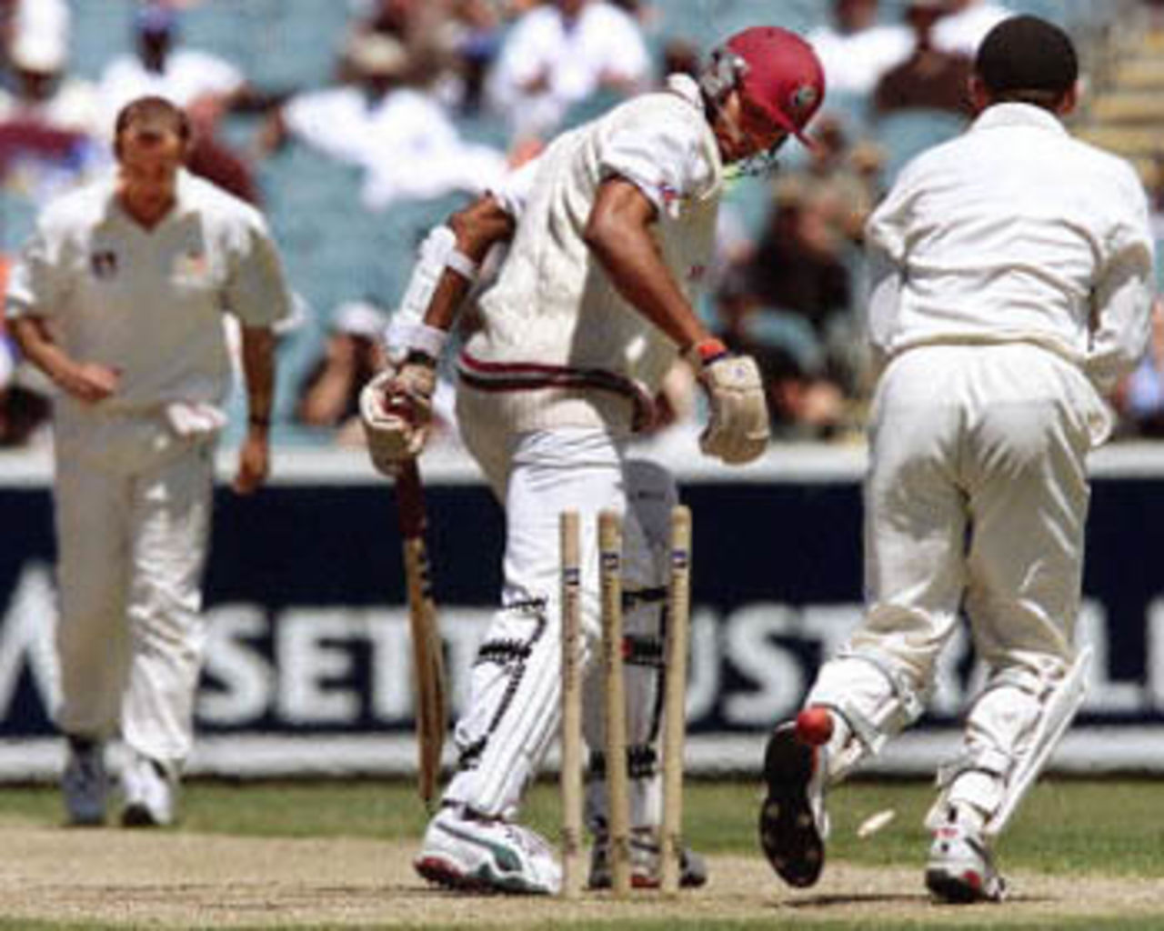 West Indian batsman Mervyn Dillon (C) is clean bowled by Australian bowler Colin Miller (L) as wicketkeeper Adam Gilchrist (R) celebrates as Australian defeats the West Indies on the fourth day of the fourth Test match at the MCG in Melbourne, 29 December 2000. Australia won the match by 352 runs with Gillespie demolishing the West Indies taking 6-40. Australia lead the series 4-0 and extend their world record winning run to fourteen consecutive victories.