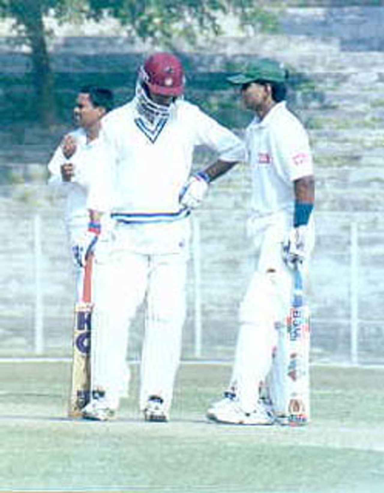 Rajesh Borah in a mid pitch conference with S Ganesh Kumar. Ranji Trophy East Zone League, 2000/01, Tripura v Assam, Maharaja Bir Bikram College Stadium, Agartala, 14-16 December 2000.
