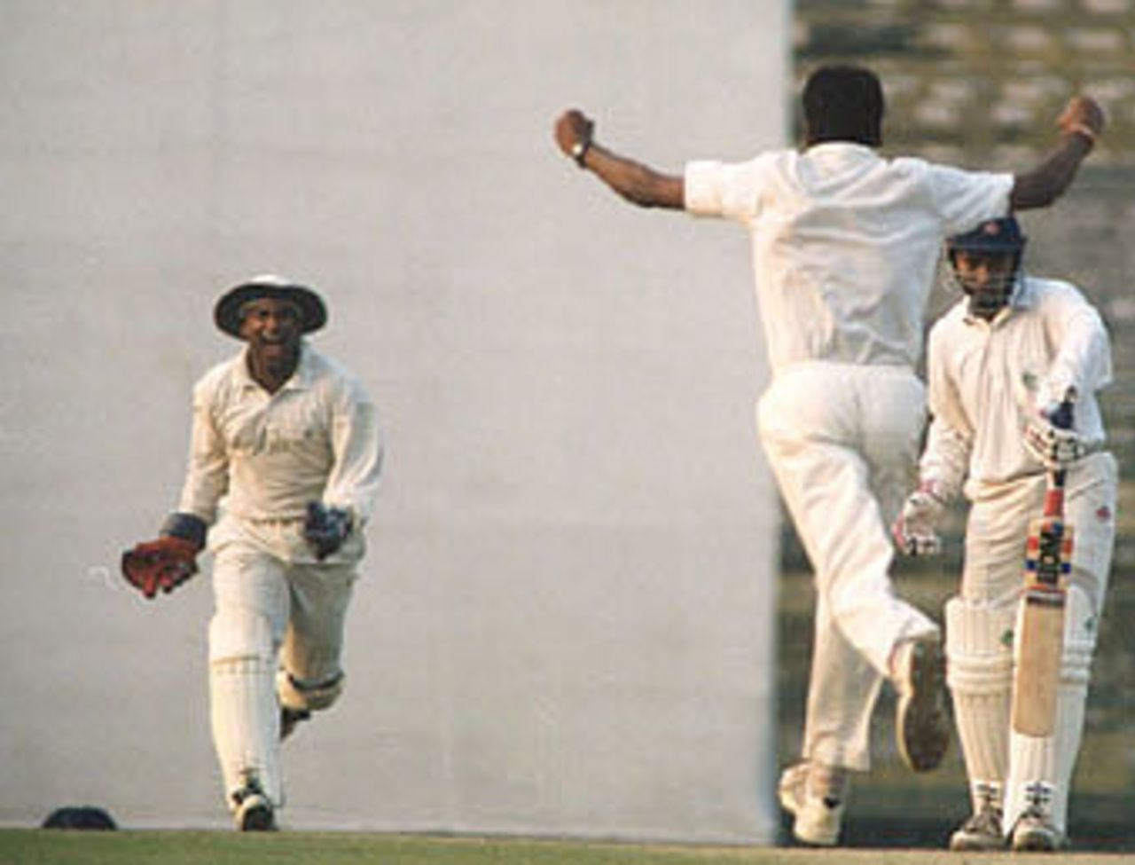 Mohanty rushes to the wicket keeper to celebrate a dismissal. Ranji Trophy East Zone League, 2000-01, Bengal v Orissa, Eden Gardens, Calcutta, 28-31 December 2000 (Day 3).