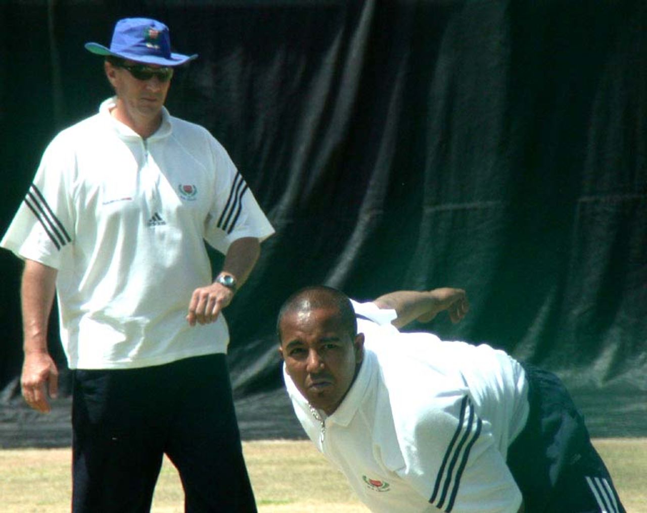 Eric Simons watches over Paul Adams in the Newlands nets on Thursday