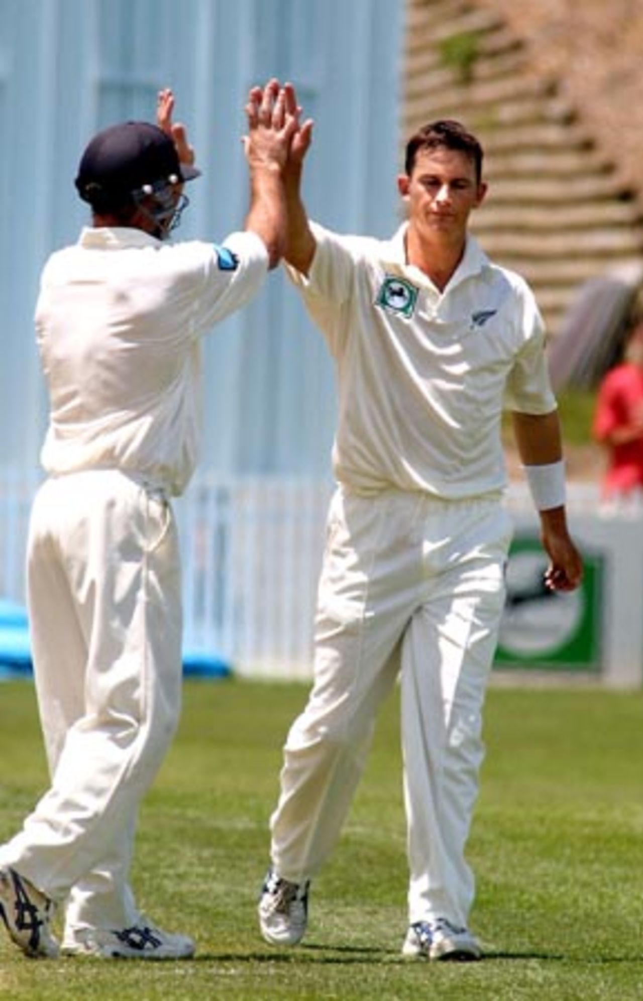 New Zealand bowler Shane Bond is high-fived by fielder Mark Richardson after dismissing Bangladesh batsman Al Sahariar, caught by Mathew Sinclair at second slip for 15 in his first innings. 1st Test: New Zealand v Bangladesh at WestpacTrust Park, Hamilton, 18-22 Dec 2001 (21 December 2001).
