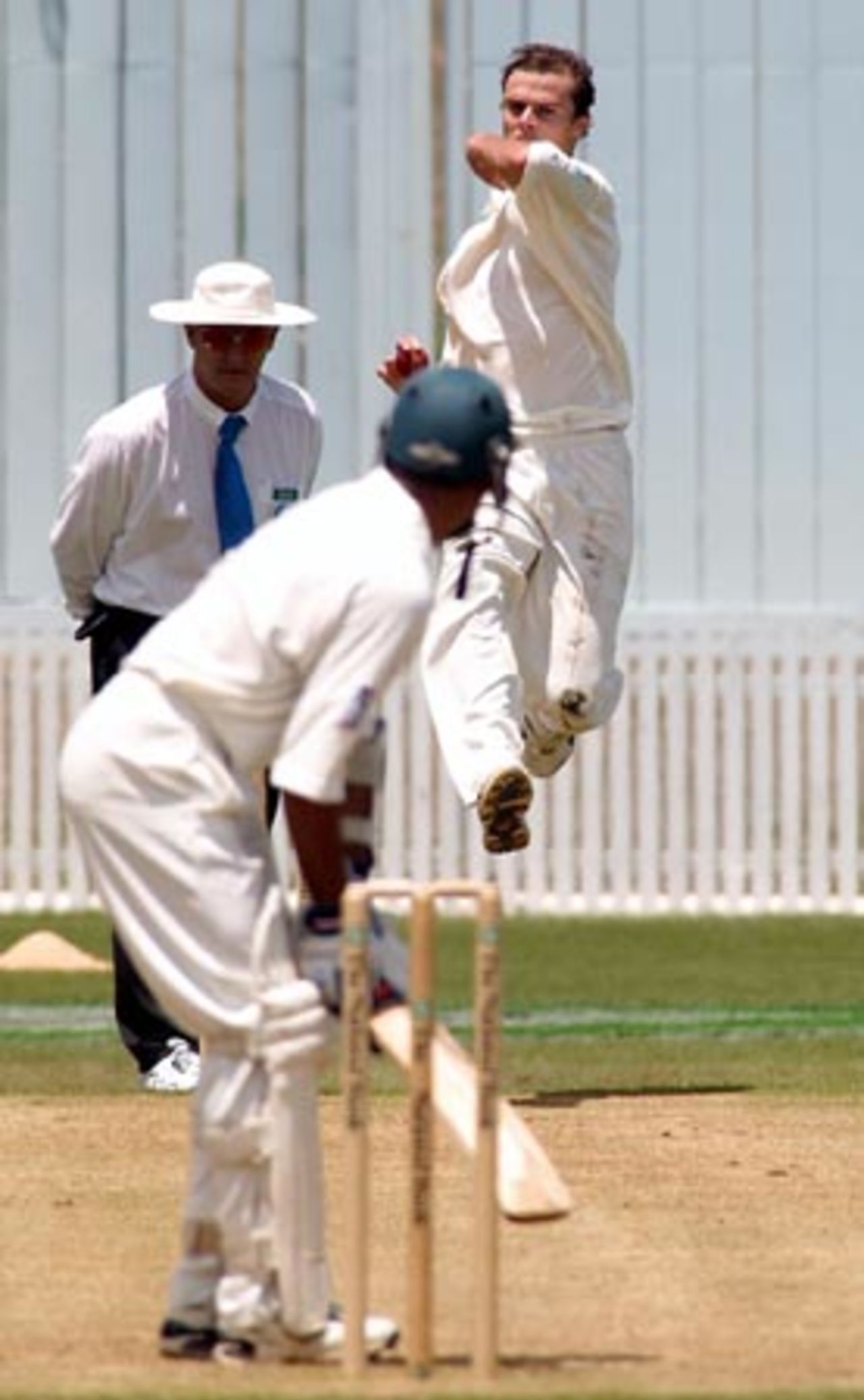New Zealand bowler Chris Martin leaps as he is about to deliver a ball to Bangladesh batsman Habibul Bashar during his first innings spell of 1-38 from 11 overs. Umpire Tony Hill looks on. 1st Test: New Zealand v Bangladesh at WestpacTrust Park, Hamilton, 18-22 Dec 2001 (21 December 2001).