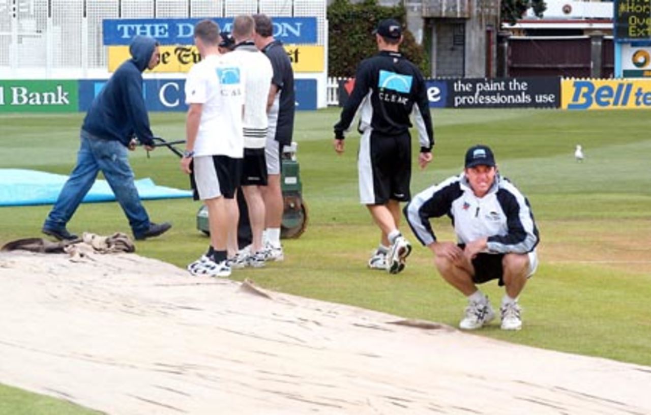New Zealand player Mark Richardson takes a look at the state of the pitch as rain prevented play on the second day. Other New Zealand players Lou Vincent (second from left), Matt Horne, coach Denis Aberhart and Mathew Sinclair (right) look at the conditions in the background. 2nd Test: New Zealand v Bangladesh at Basin Reserve, Wellington, 26-30 Dec 2001 (27 December 2001).