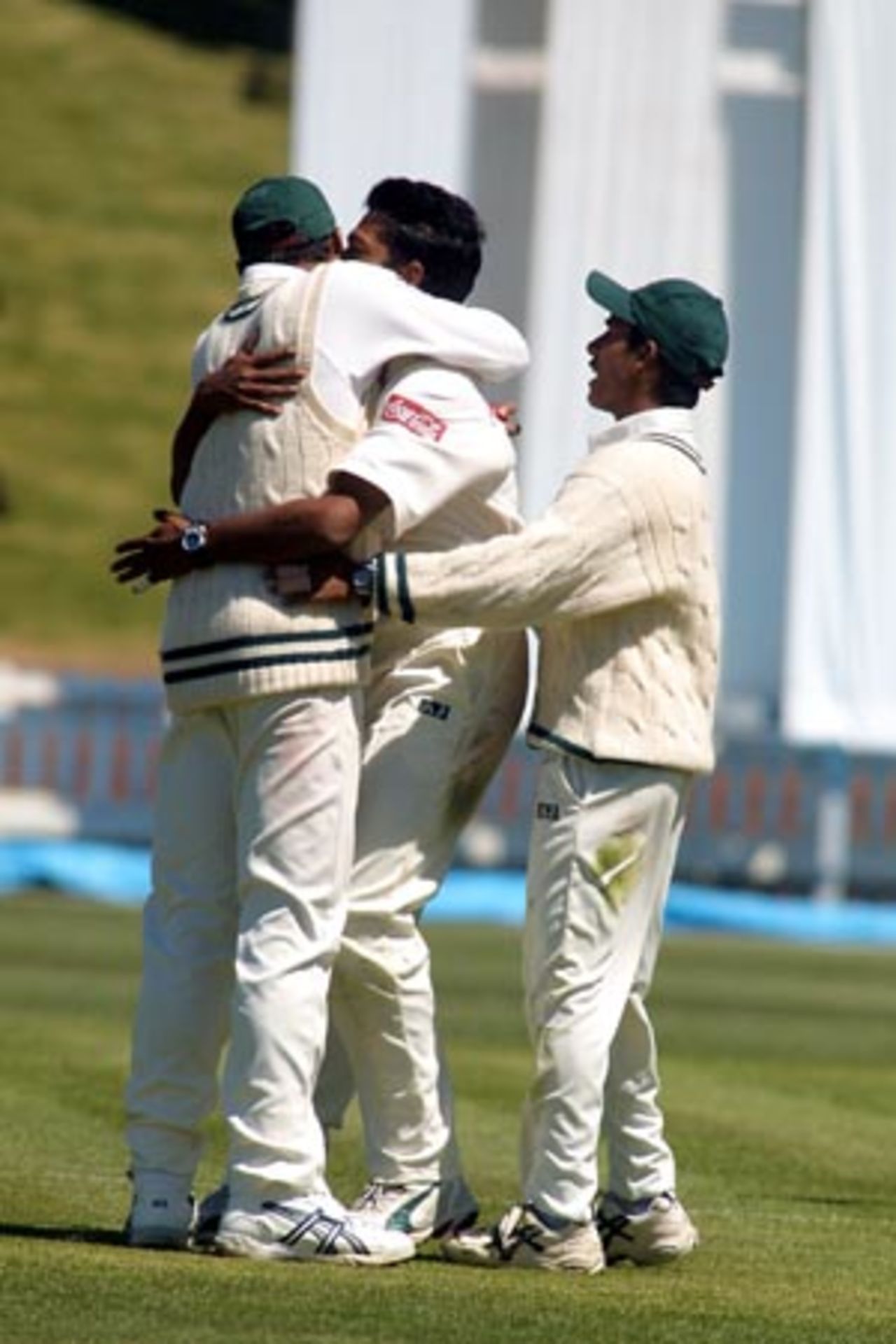 Bangladesh bowler Hasibul Hossain (centre) hugs Mashrafe Mortaza in celebration after dismissing New Zealand batsman Mark Richardson, caught by Mashrafe at mid on for 83. Captain Khaled Mashud (right) joins in the celebration. 2nd Test: New Zealand v Bangladesh at Basin Reserve, Wellington, 26-30 Dec 2001 (29 December 2001).