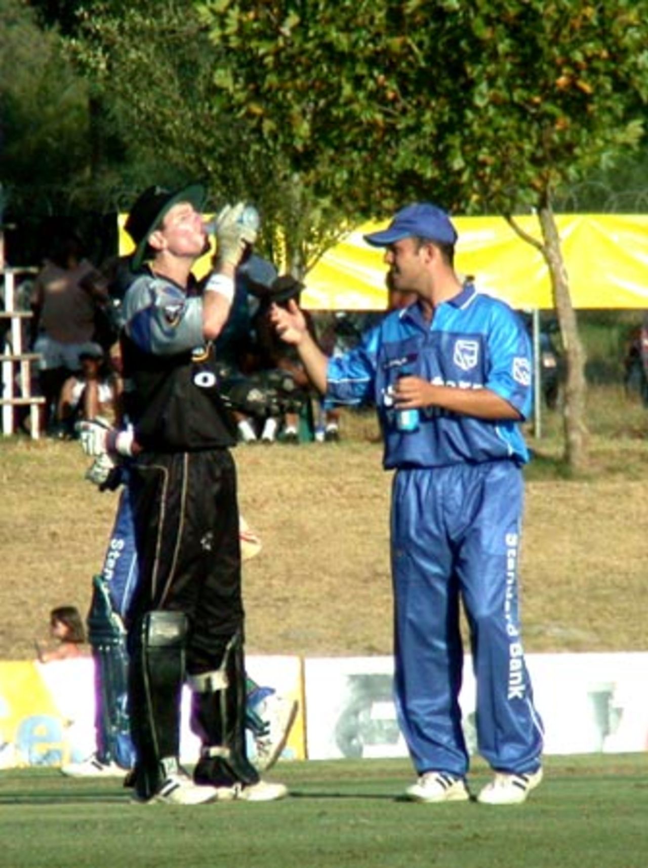 WP 12th man Jonathan Trott shares a drink with Boland wicketkeeper Steve Palframan during a Standard Bank Cup match at Paarl on Friday