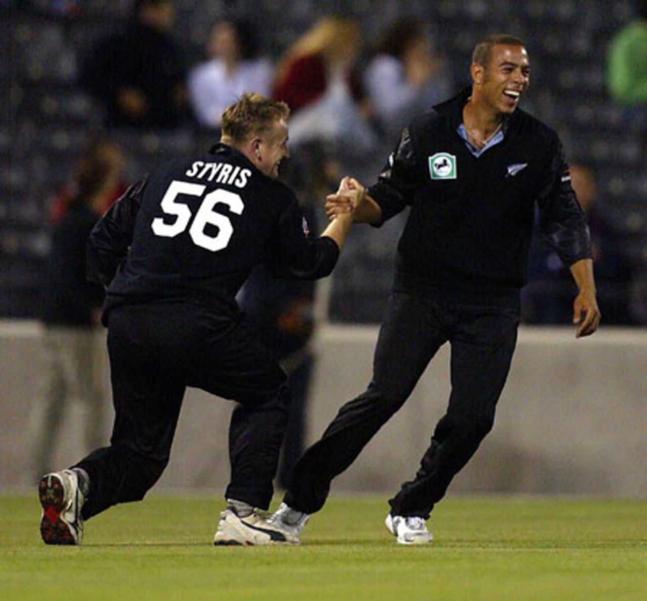 New Zealand players Scott Styris (left) and Andre Adams celebrate the dismissal of Indian batsman Sachin Tendulkar, caught by Styris off the bowling of Jacob Oram in his second innings for five. Super Max International: New Zealand v India at Jade Stadium, Christchurch, 4 December 2002.