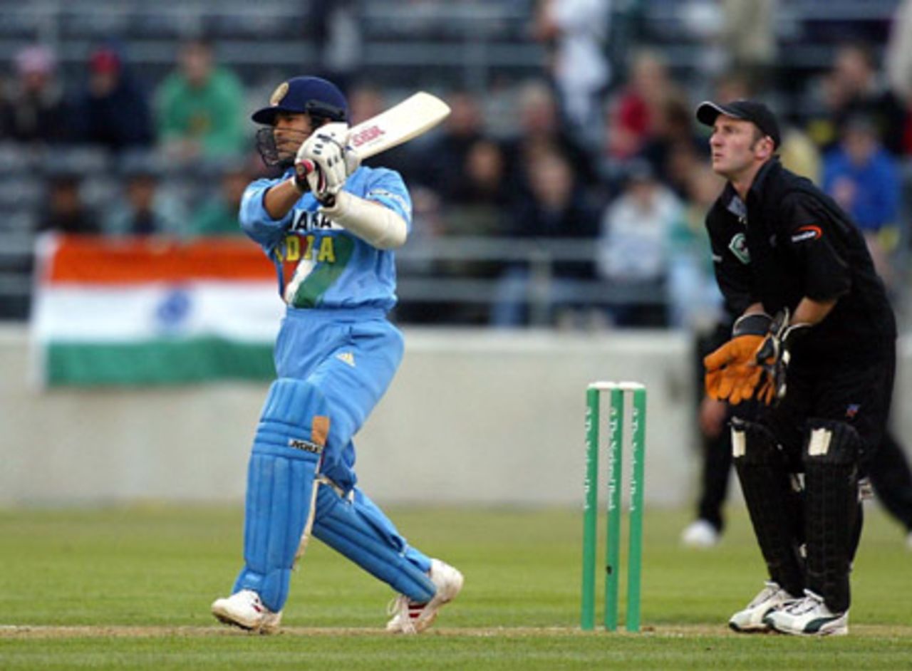 Indian batsman Tendulkar lofts a delivery down the ground during his first innings of 72 as New Zealand wicket-keeper Chris Nevin looks on. Super Max International: New Zealand v India at Jade Stadium, Christchurch, 4 December 2002.