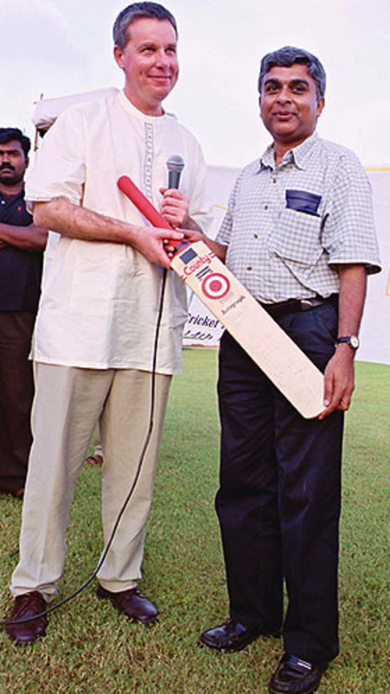 George Abraham presents a bat signed by the Indian team to one of the special invitees
