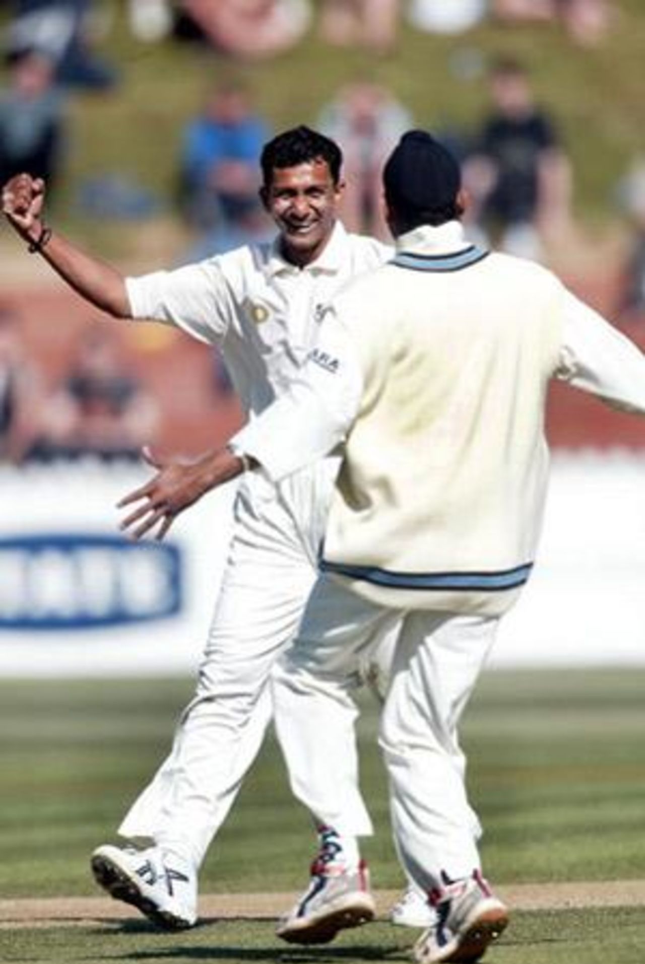 Indian bowler Sanjay Bangar (left) and team-mate Harbhajan Singh celebrate the dismissal of New Zealand batsman Craig McMillan, lbw to Bangar in his first innings for nine. 1st Test: New Zealand v India at Basin Reserve, Wellington, 12-16 December 2002 (13 December 2002).