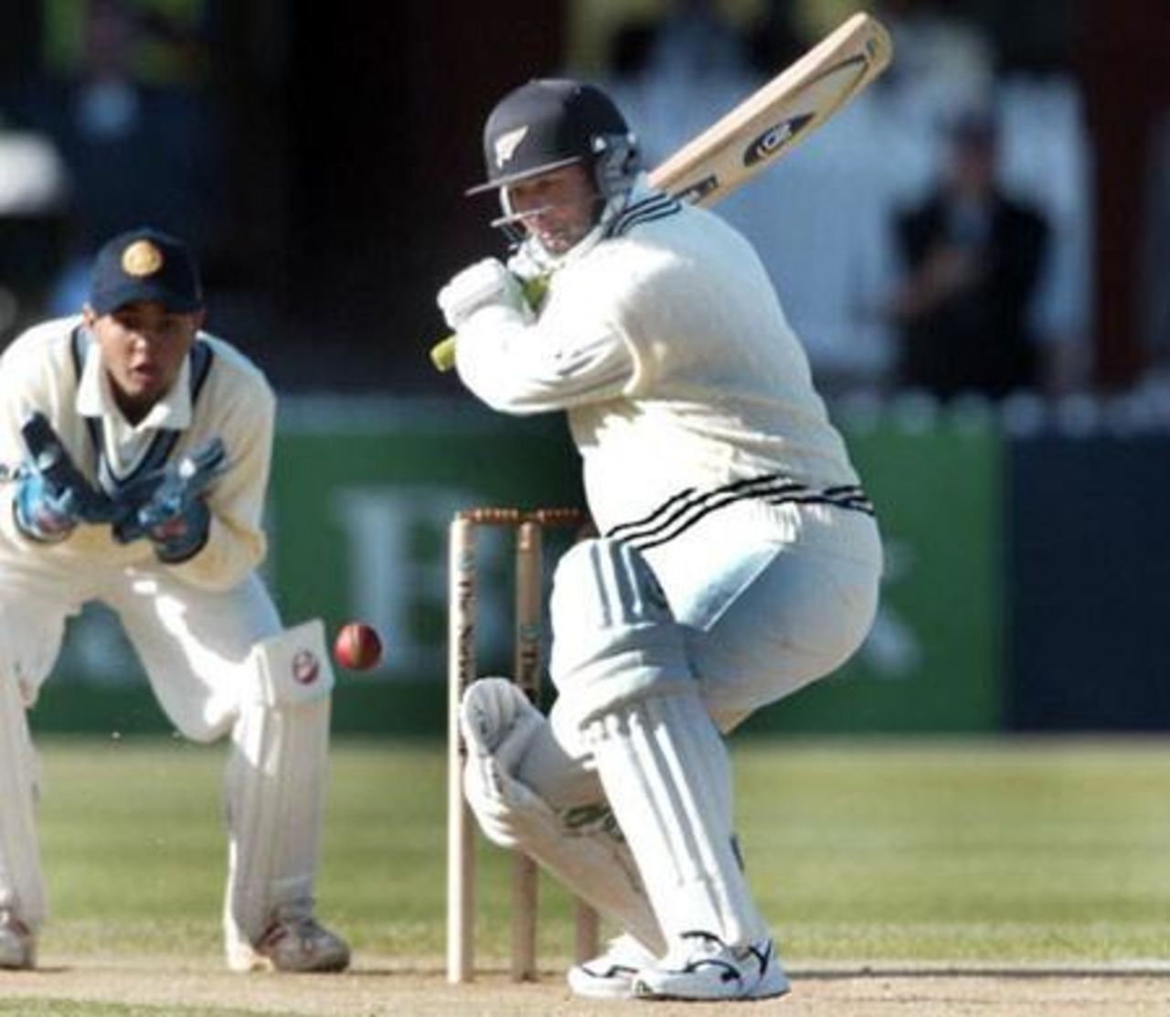 New Zealand batsman Nathan Astle shapes to cut a delivery from Indian bowler Harbhajan Singh during his first innings of 41 as wicket-keeper Parthiv Patel looks on. 1st Test: New Zealand v India at Basin Reserve, Wellington, 12-16 December 2002 (13 December 2002).