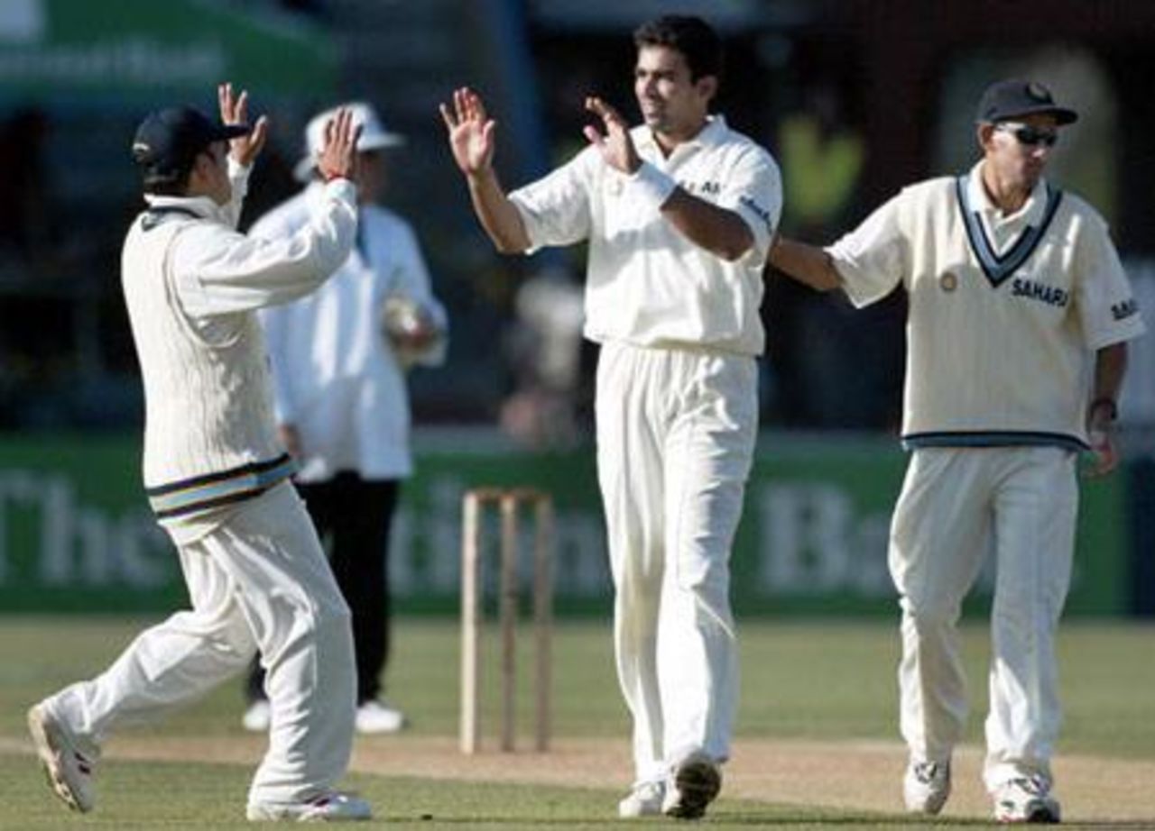 Indian bowler Zaheer Khan (centre) celebrates the dismissal of New Zealand batsman Nathan Astle, caught by Harbhajan Singh for 41 in his first innings, with team-mates Sachin Tendulkar (left) and Ajit Agarkar. 1st Test: New Zealand v India at Basin Reserve, Wellington, 12-16 December 2002 (13 December 2002).
