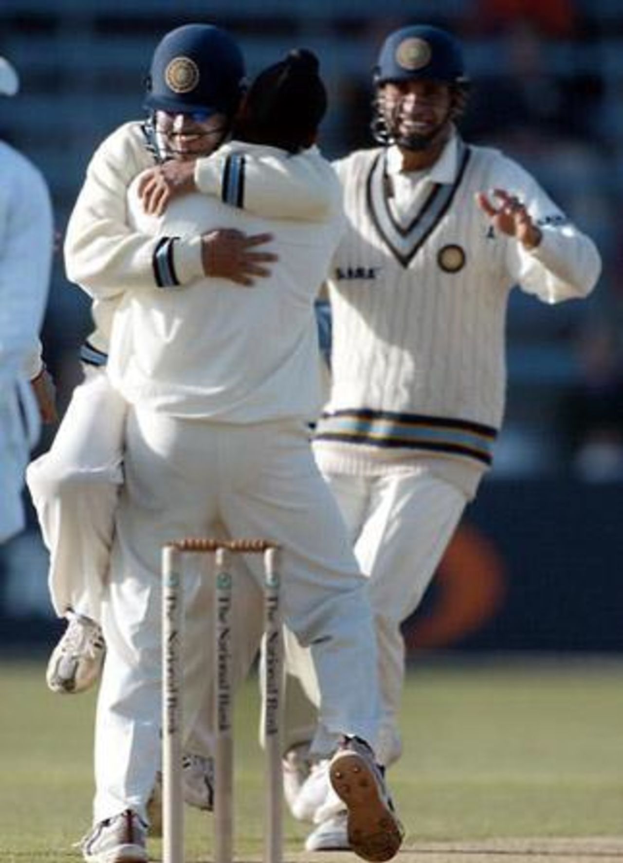 Indian fielder Virender Sehwag (left) hugs Harbhajan Singh to celebrate the dismissal of New Zealand batsman Jacob Oram, lbw off the bowling of Harbhajan for 0, as team-mate VVS Laxman looks on. 1st Test: New Zealand v India at Basin Reserve, Wellington, 12-16 December 2002 (13 December 2002).