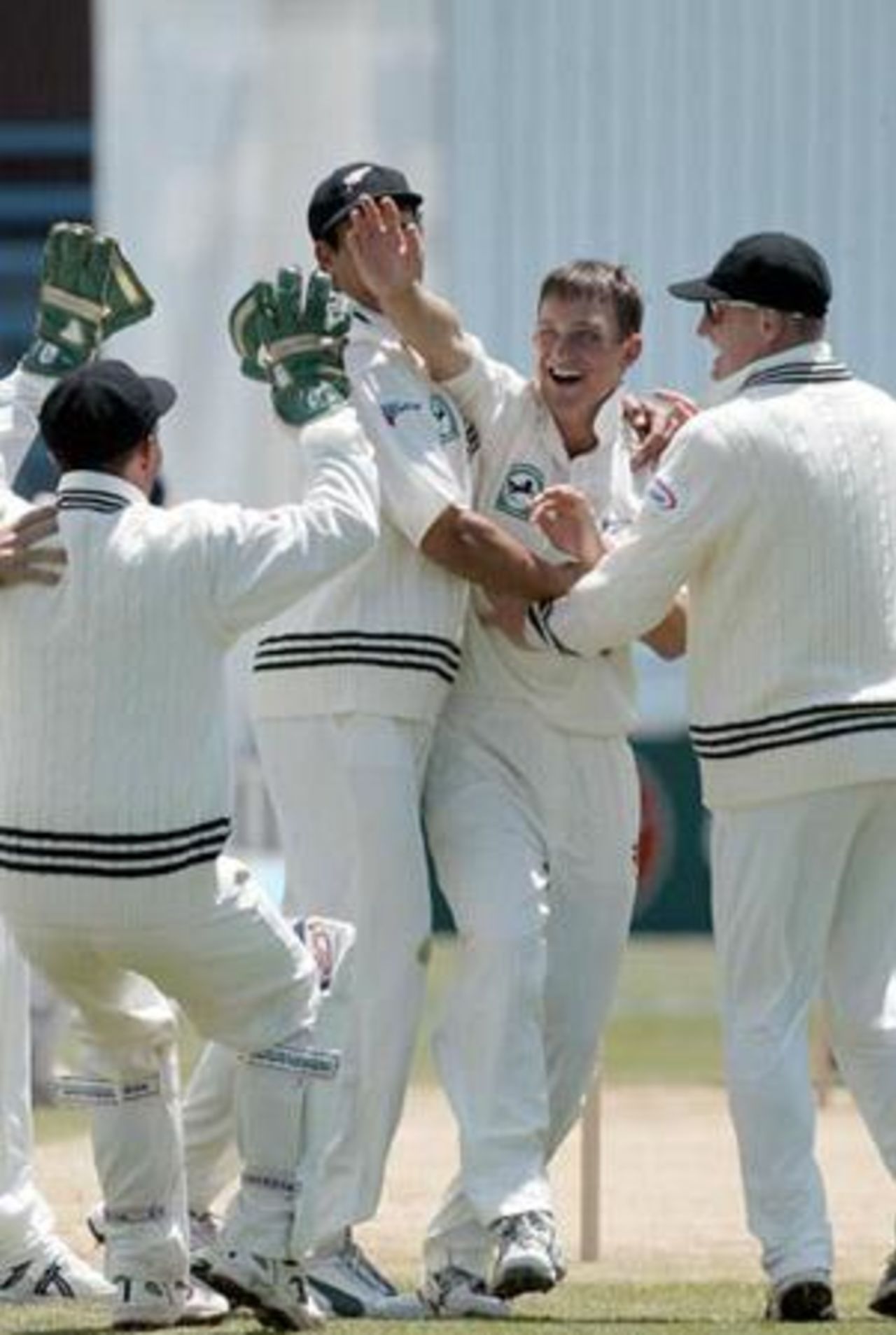 Members of the New Zealand team celebrate the dismissal of Indian batsman Sourav Ganguly, caught by wicket-keeper Robbie Hart off the bowling of Shane Bond for two. From left: Hart, Daryl Tuffey (obscured), Bond and Scott Styris. 1st Test: New Zealand v India at Basin Reserve, Wellington, 12-16 December 2002 (14 December 2002).