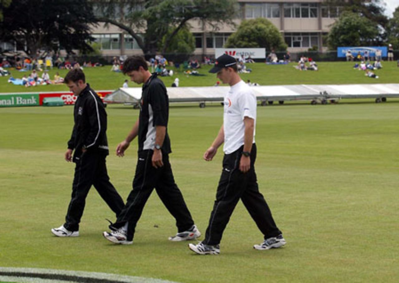 New Zealand players Nathan Astle (left), Stephen Fleming and Shane Bond walk from the field after checking the condition of the ground as the start of play is delayed. Play was eventually abandoned on day one. 2nd Test: New Zealand v India at Westpac Park, Hamilton, 19-23 December 2002 (19 December 2002).
