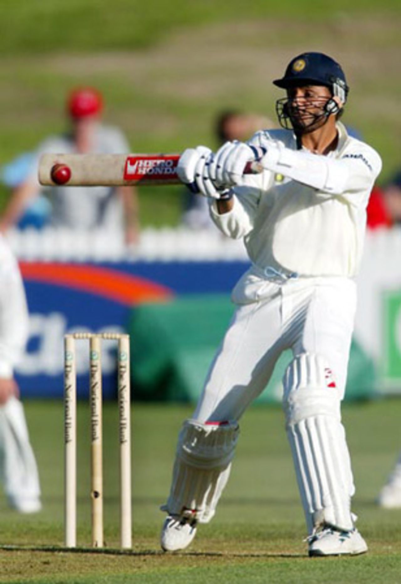 Indian batsman Harbhajan Singh hits a delivery from New Zealand bowler Shane Bond to the cover boundary for four during his first innings of 20.