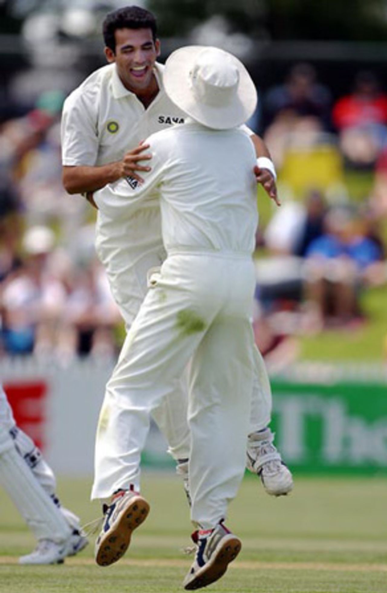 Indian bowler Zaheer Khan (left) and team-mate Harbhajan Singh celebrate the dismissal of New Zealand batsman Robbie Hart, lbw to Khan for three in his first innings. 2nd Test: New Zealand v India at Westpac Park, Hamilton, 19-23 December 2002 (21 December 2002).