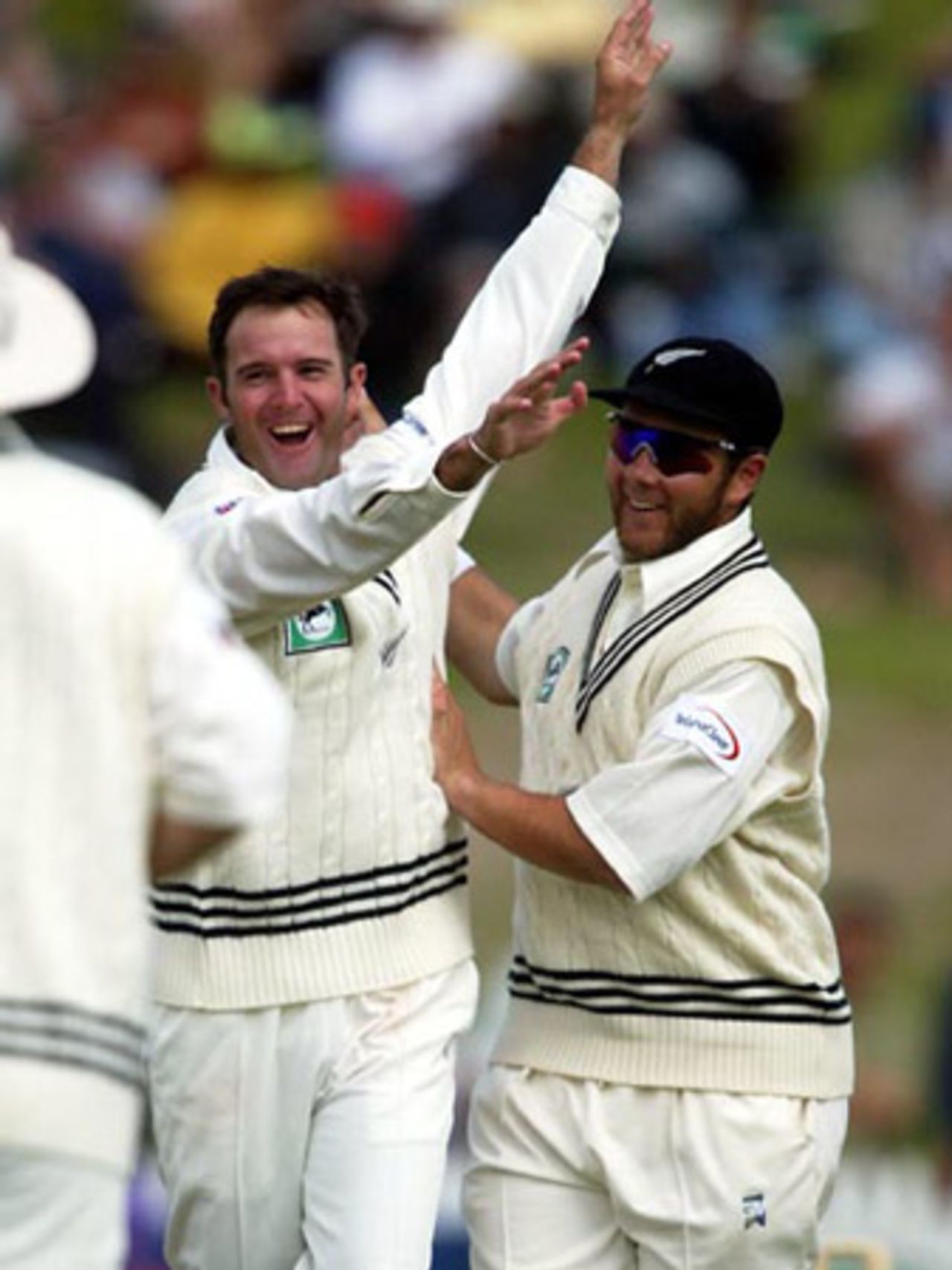 New Zealand bowler Nathan Astle (left) and team-mate Craig McMillan celebrate the dismissal of Indian batsman VVS Laxman, bowled by Astle for four. 2nd Test: New Zealand v India at Westpac Park, Hamilton, 19-23 December 2002 (21 December 2002).