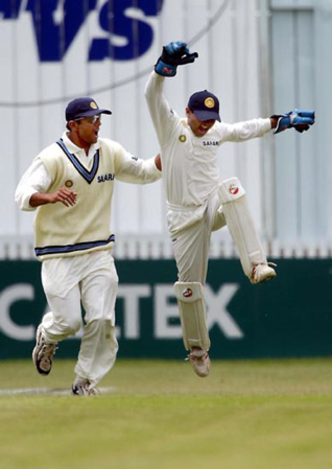 Indian fielder Rahul Dravid (left) and wicket-keeper Parthiv Patel celebrate the dismissal of New Zealand batsman Nathan Astle, caught by Patel off the bowling of Zaheer Khan for 14 in his second innings. 2nd Test: New Zealand v India at Westpac Park, Hamilton, 19-23 December 2002 (22 December 2002).
