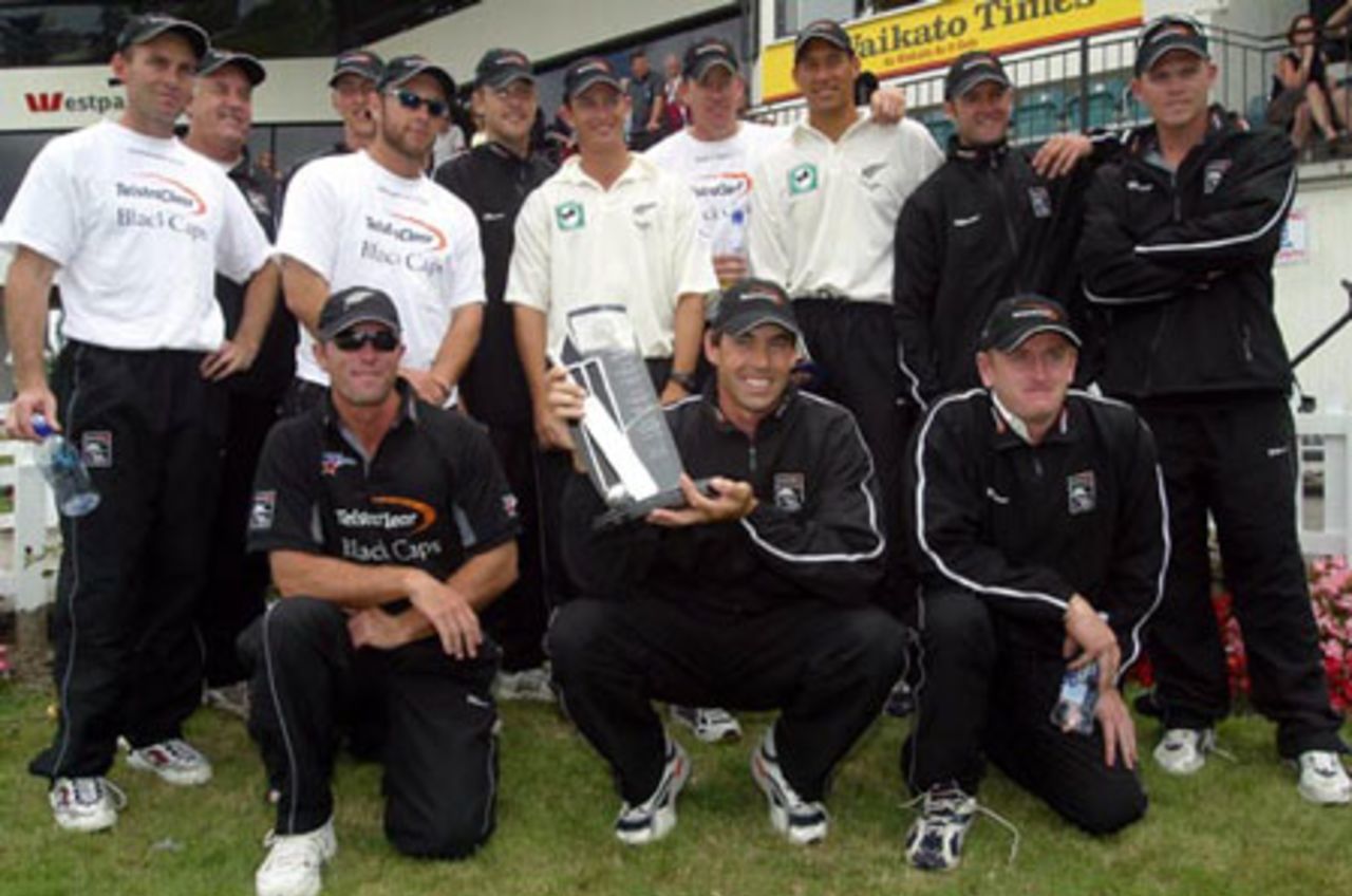 Members of the New Zealand team pose with the National Bank trophy after winning the two-Test series against India 2-0. Back, from left: Robbie Hart, coach Denis Aberhart, 12th man Michael Mason (partially obscured), Craig McMillan, Daniel Vettori, Shane Bond, Jacob Oram, Daryl Tuffey, Nathan Astle and Lou Vincent. Front: Mark Richardson, Stephen Fleming and Scott Styris. 2nd Test: New Zealand v India at Westpac Park, Hamilton, 19-23 December 2002 (22 December 2002).