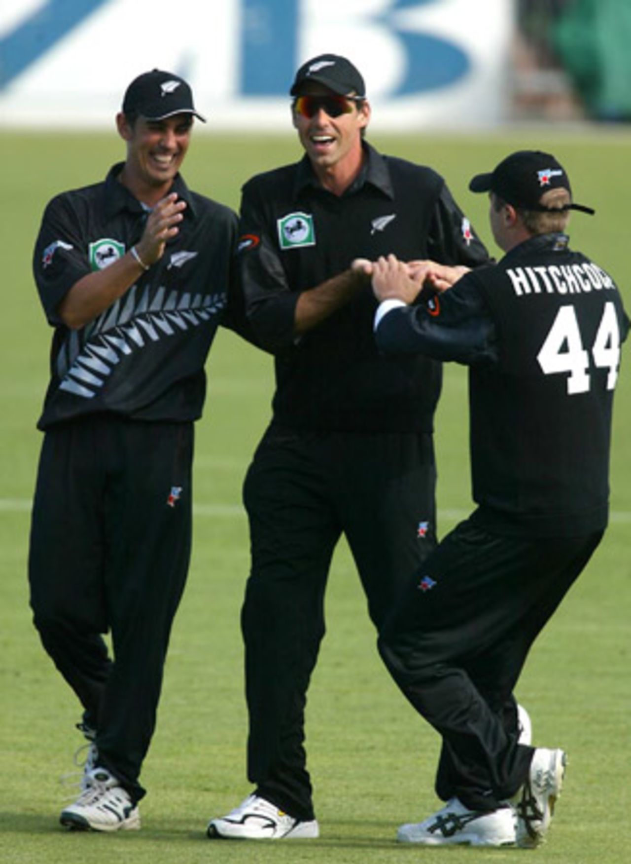 New Zealand players Mathew Sinclair (left), Stephen Fleming and Paul Hitchcock celebrate the dismissal of Indian batsman Rahul Dravid, run out by Fleming for 18. 2nd ODI: New Zealand v India at McLean Park, Napier, 29 December 2002.