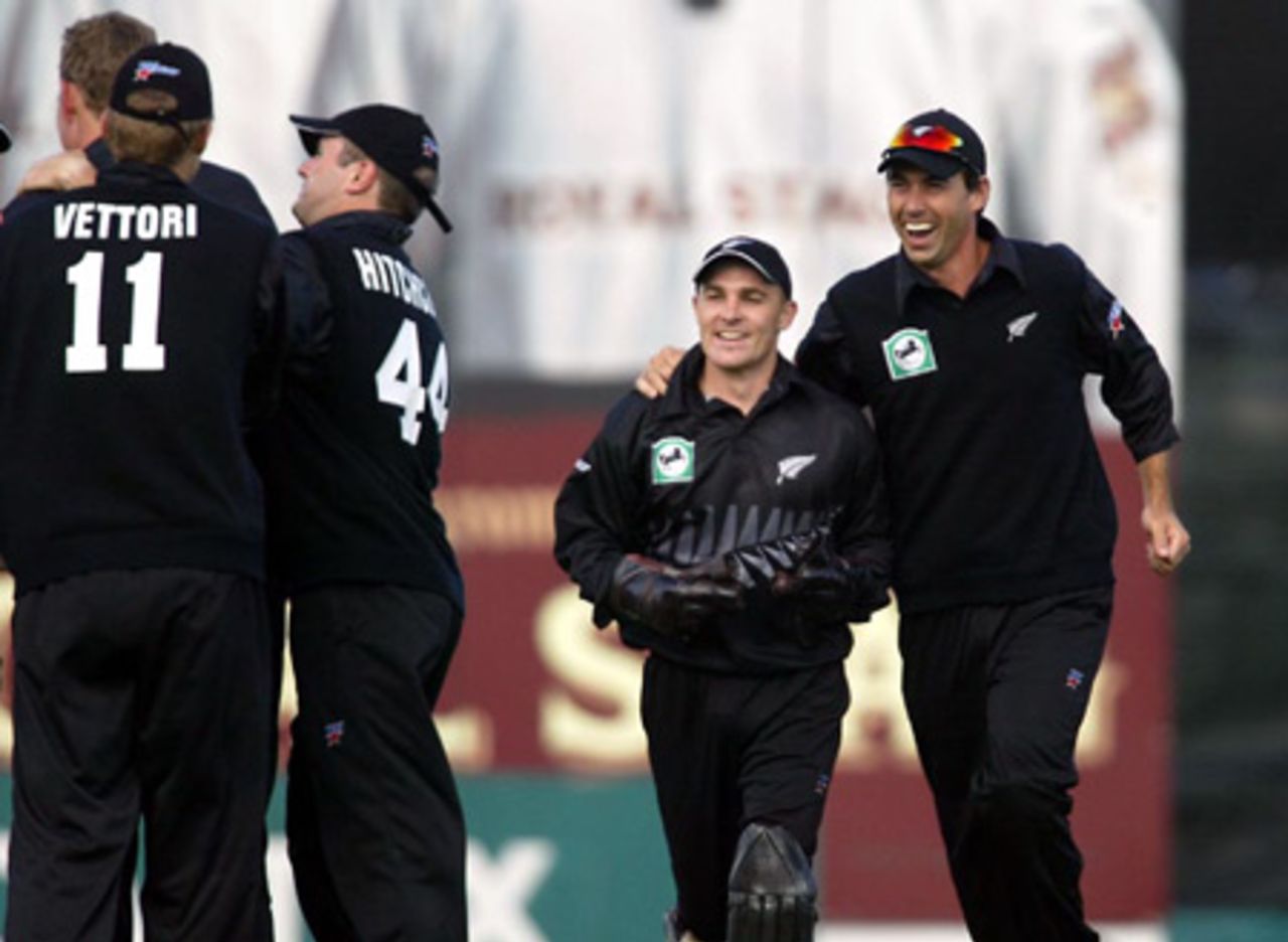 Members of the New Zealand team celebrate the dismissal of Indian batsman Sanjay Bangar, caught by wicket-keeper Brendon McCullum off the bowling of Jacob Oram for four. From left: Oram (obscured), Daniel Vettori, Paul Hitchcock, McCullum and Stephen Fleming. 2nd ODI: New Zealand v India at McLean Park, Napier, 29 December 2002.