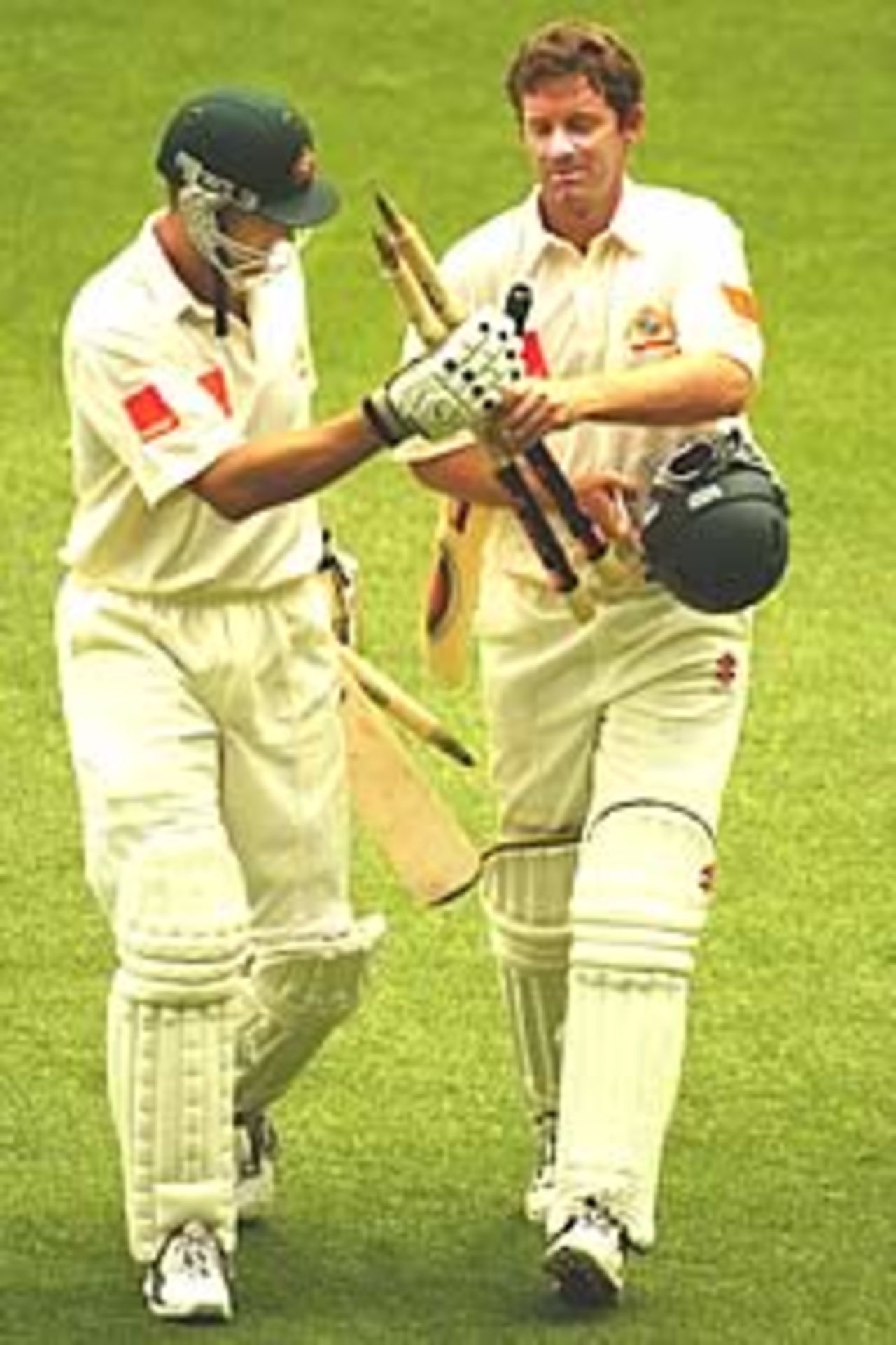 MELBOURNE - DECEMBER 30: Adam Gilchrist and Martin Love of Australia leave the field with stumps in hand after winning the fifth day of the Fourth Ashes Test between Australia and England at the Melbourne Cricket Ground in Melbourne, Australia on December 30, 2002.