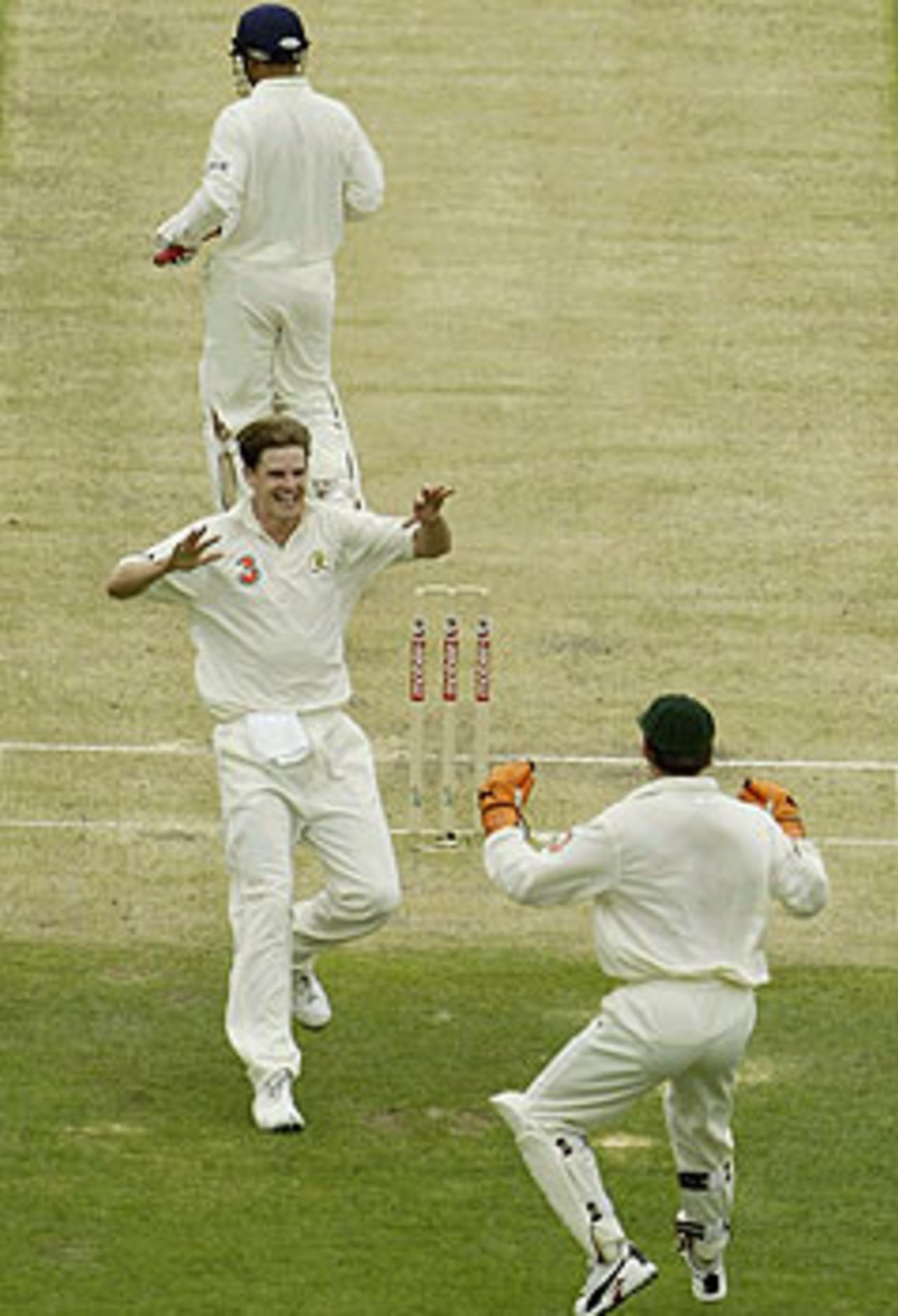 My first time! Nathan Bracken rushes to Adam Gilchrist after picking up his first Test wicket, that of Virender Sehwag, Australia v India, 1st Test, Brisbane, 4th day, December 7, 2003