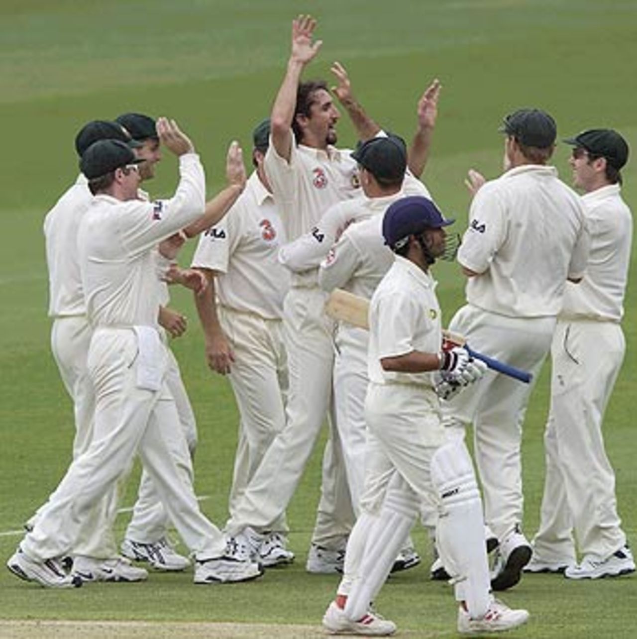 Sachin Tendulkar walks off as Jason Gillespie celebrates with his mates, Australia v India, 1st Test, Brisbane, 4th day, December 7, 2003