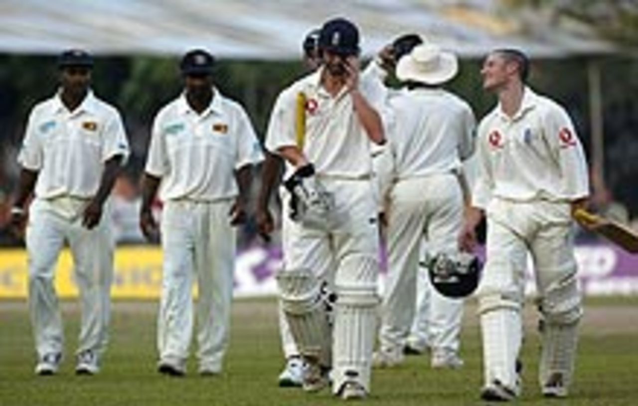 The end of a long day - Gareth Batty and Chris Read lead the players from the field