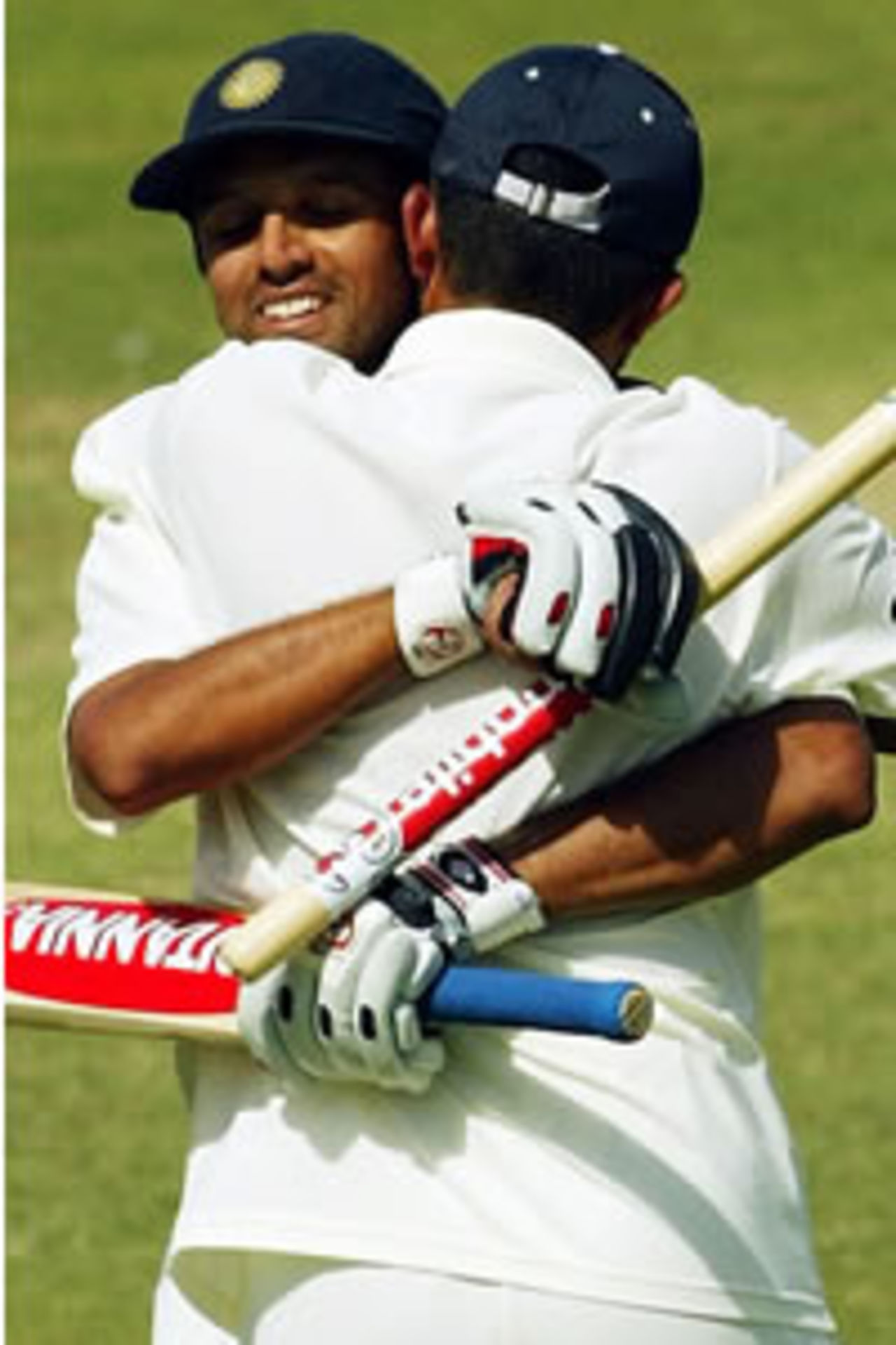 India batsman Rahul Dravid (L) is congratulated by captain Sourav Ganguly (R) after defeating Australia on the final day of the second Test Match being played in Adelaide 16 December 2003.