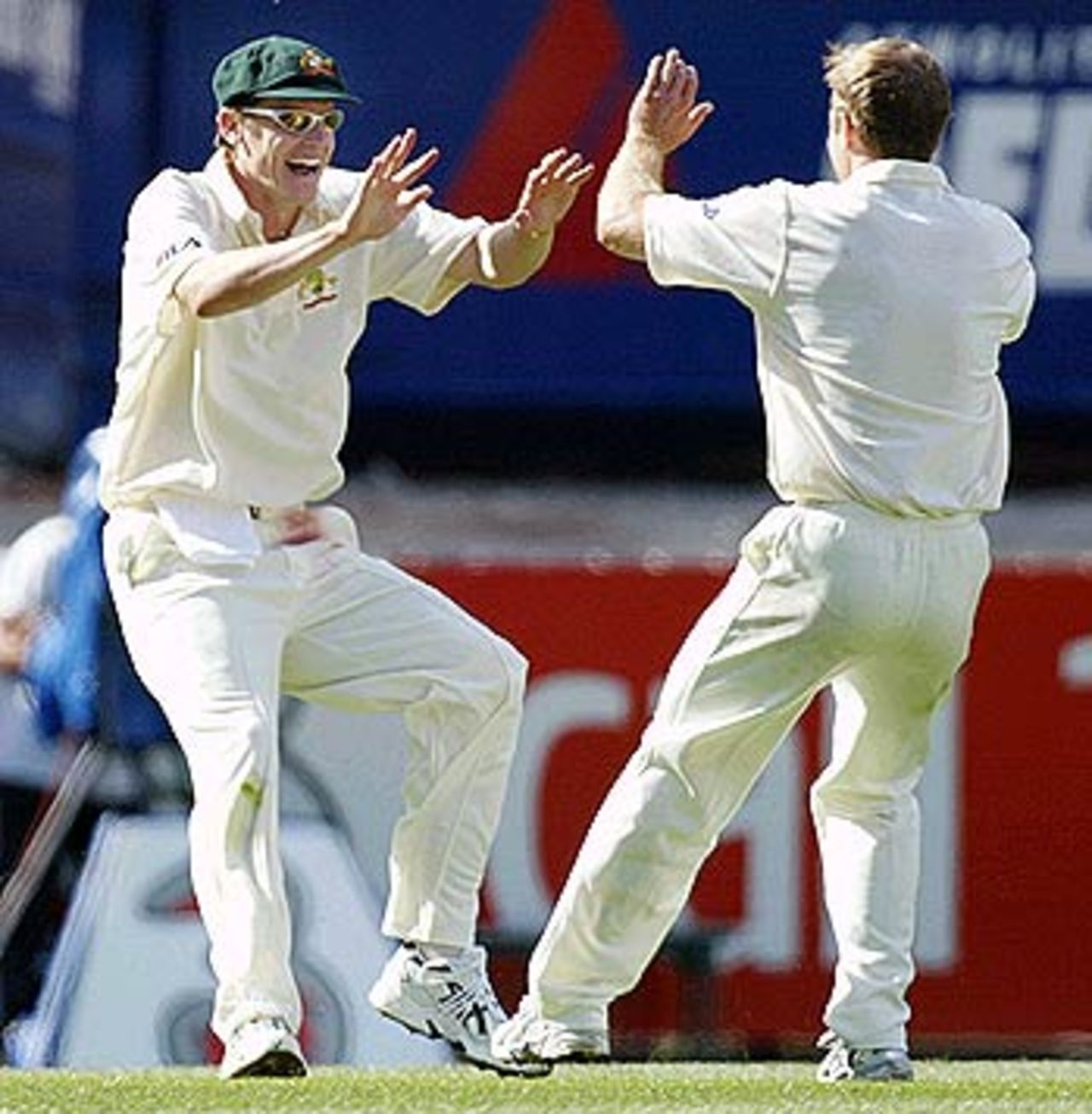 Gimme 195. Nathan Bracken and Simon Katich celebrate the wicket of Virender Sehwag, Australia v India, 3rd Test, Melbourne, 1st day, December 26, 2003