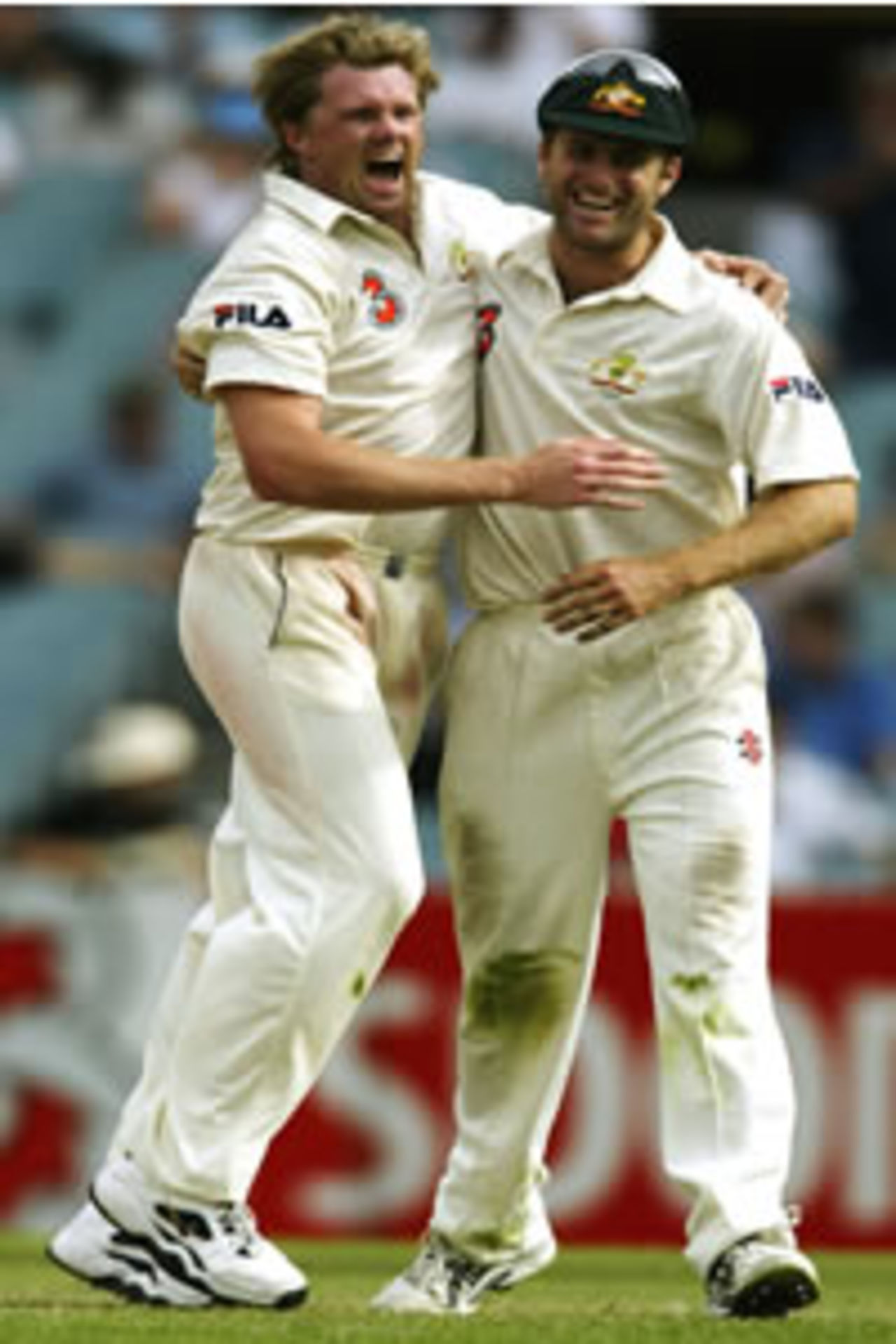 Brad Williams of Australia is congratulated by Simon Katich on the wicket of Anil Kumble during day four of the 3rd Test between Australia and India at the MCG on December 29, 2003 in Melbourne, Australia