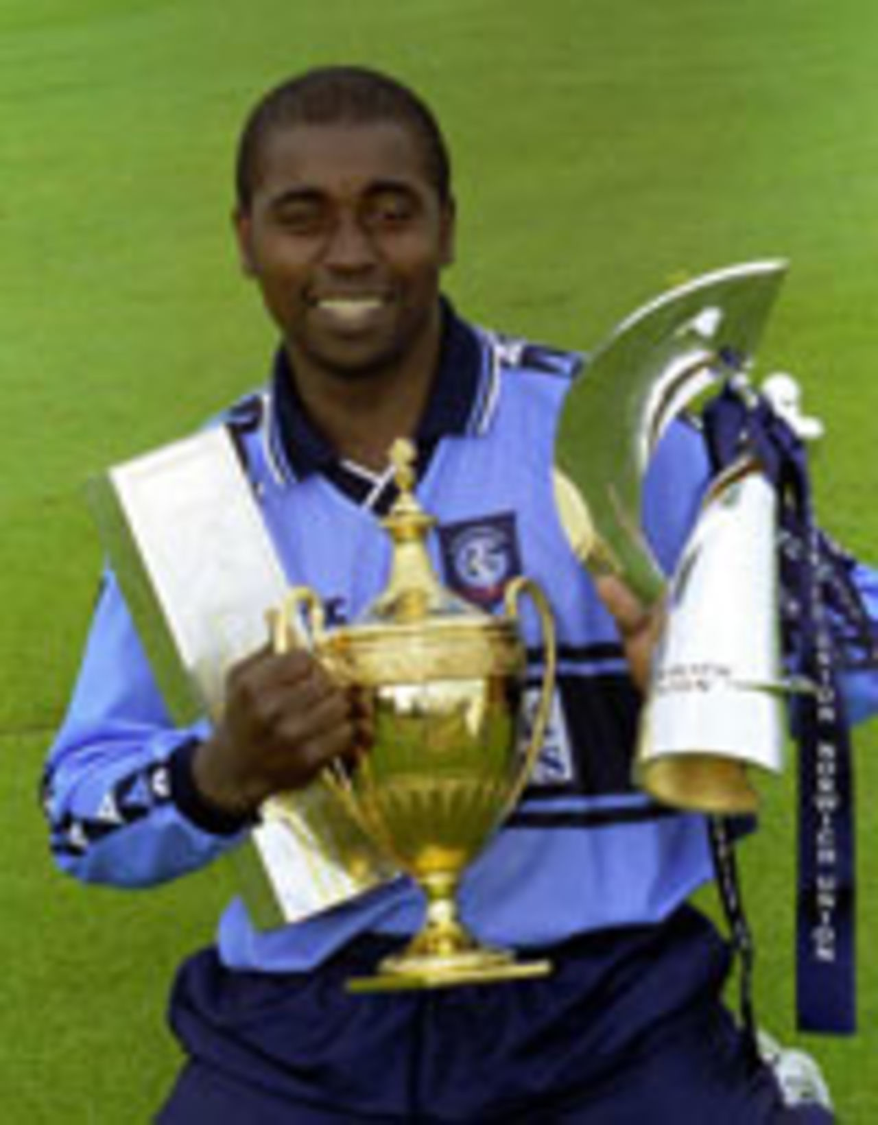 Mark Alleyne with three trophies, September 17, 2000