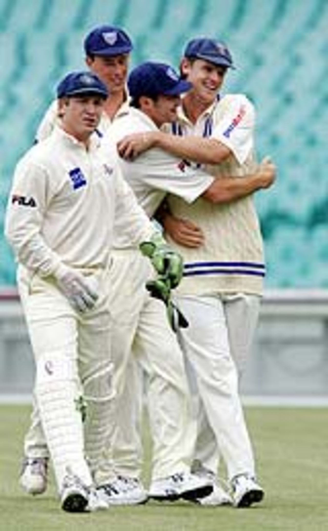 Nathan Bracken is congratulated by teammates, NSW v SA, Pura Cup, Sydney, December 2, 2004