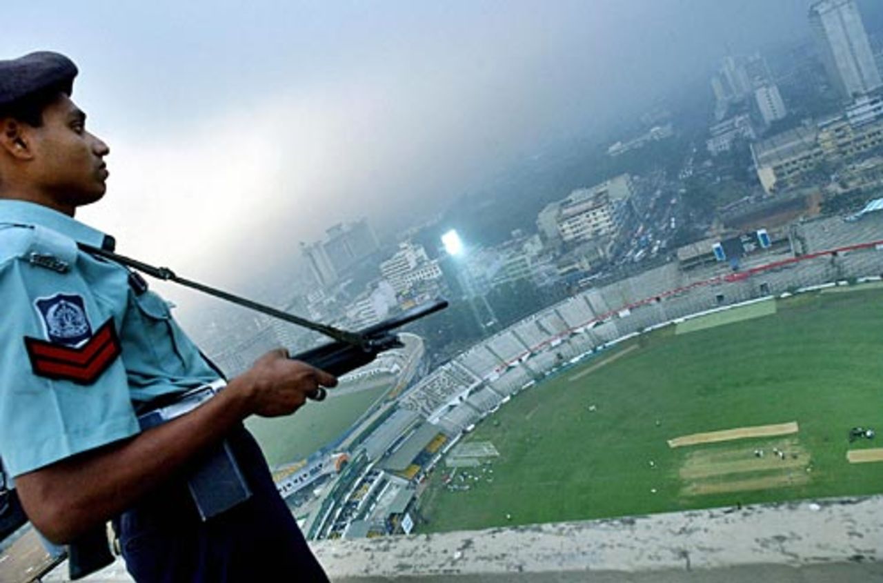 An armed guard watches over the Bangabandhu National Stadium in Dhaka, December 9, 2004