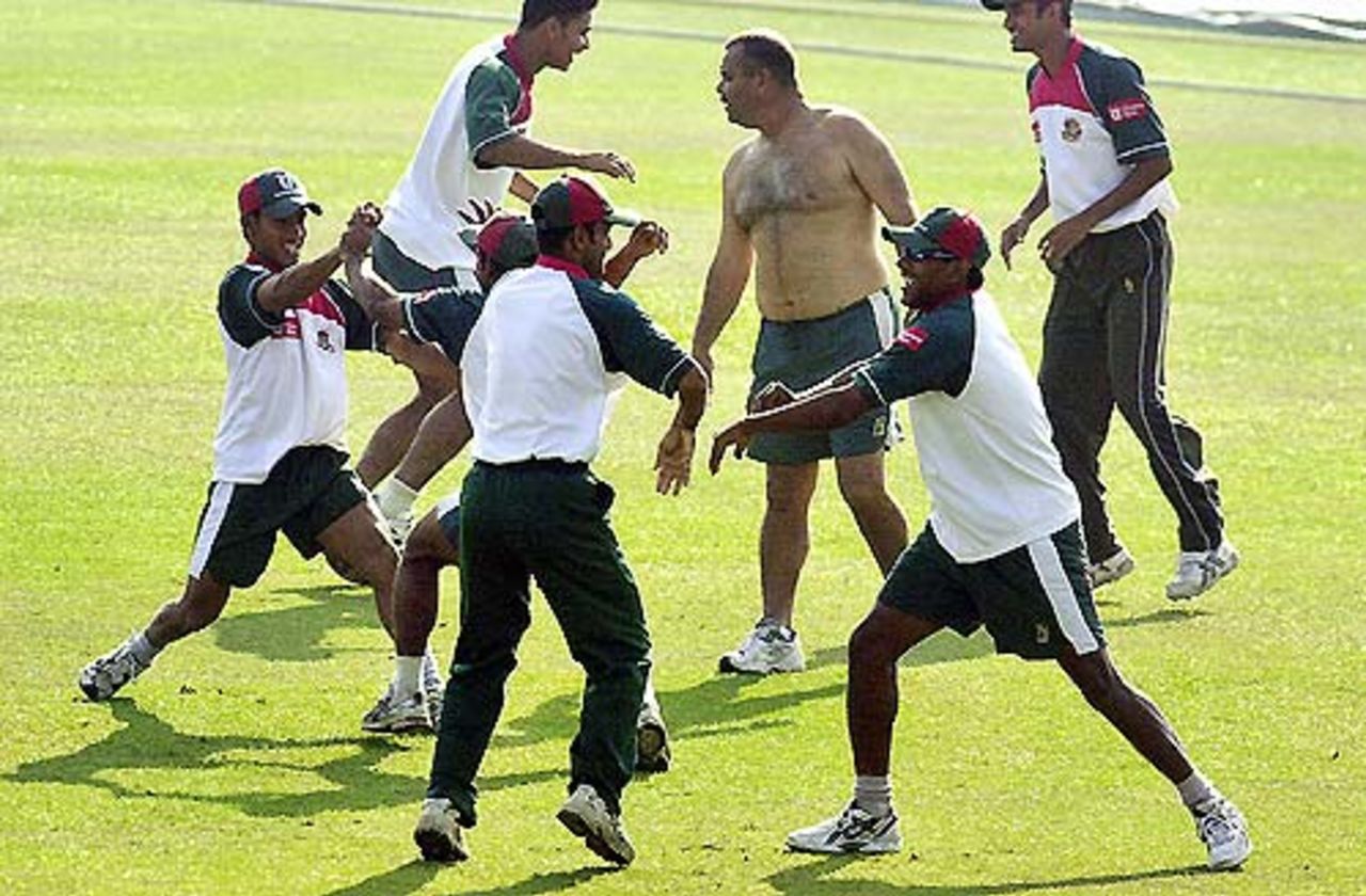 Dav Whatmore joins the Bangladesh players in a stretching session on the eve of the second Test, Chittagong, December 16, 2004