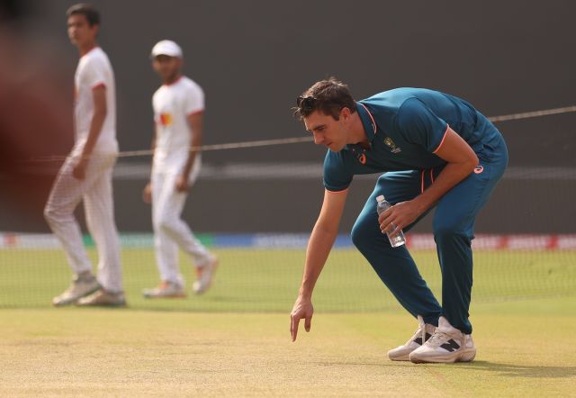 Pat Cummins inspects the pitch ahead of the final