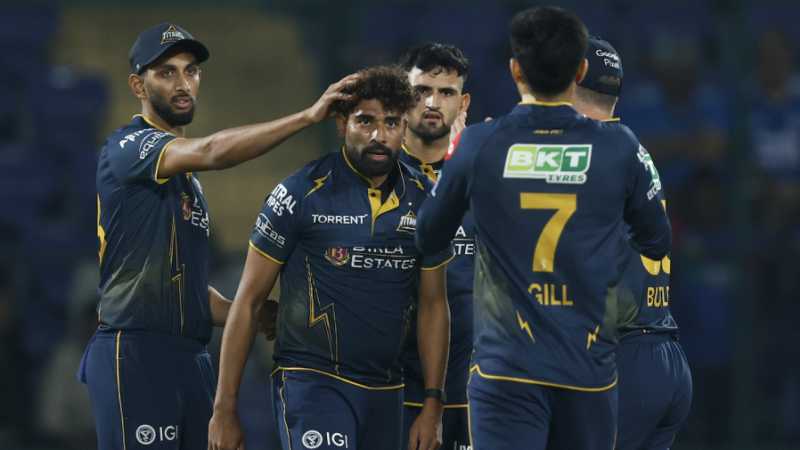 Gujarat Titans players celebrating a wicket against Lucknow Super Giants at Ekana Stadium