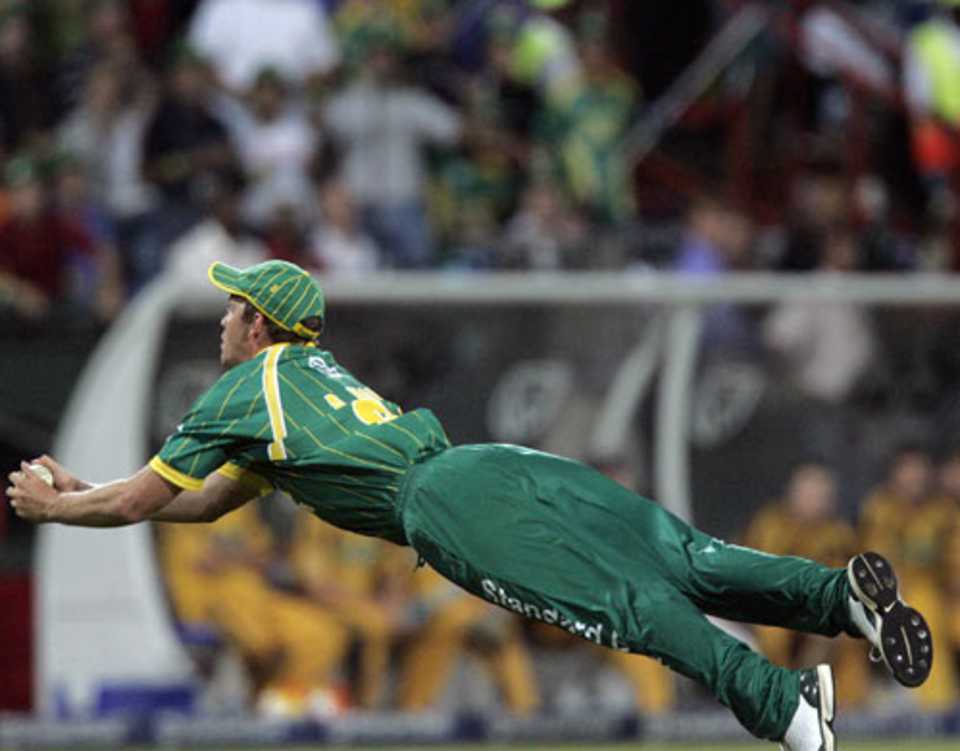 Albie Morkel completes a diving catch to get rid of James Hopes