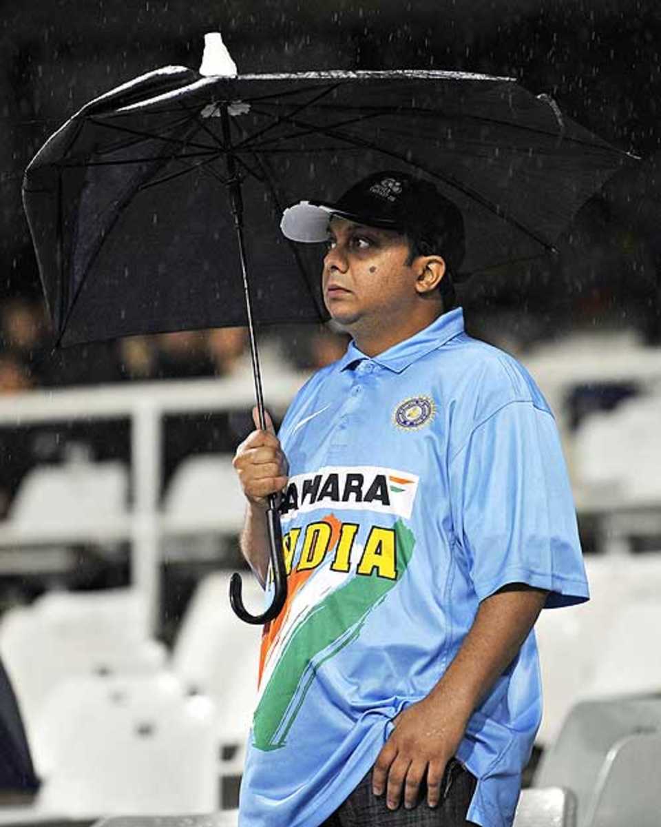 An Indian fan waits in vain for the game to start