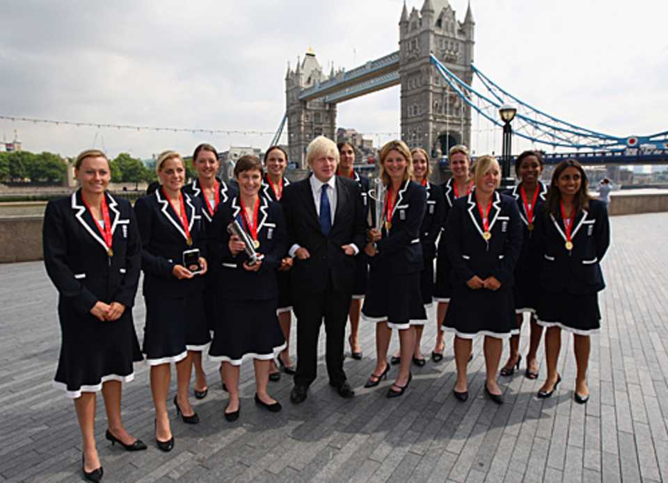 The victorious England women's team pose with the ICC World Twenty20 trophy in front of Tower Bridge with the London mayor, Boris Johnson