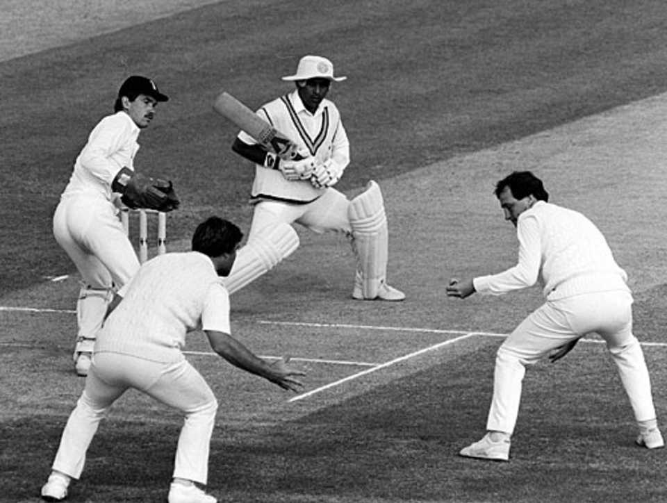Sunil Gavaskar watches as a shot goes by slip fielders