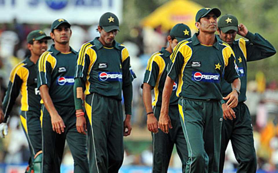 Younis Khan leads his team off the field after the defeat