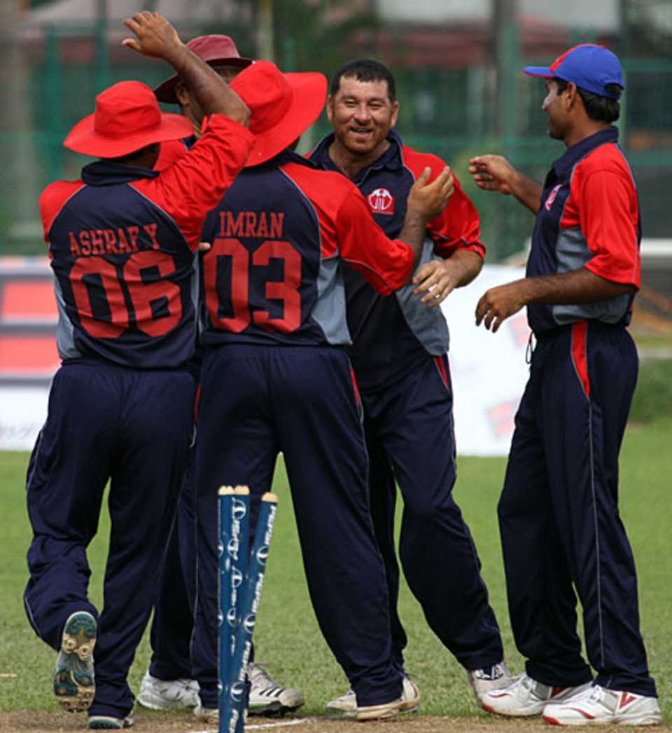 Halal Abbasi is congratulated for a wicket
