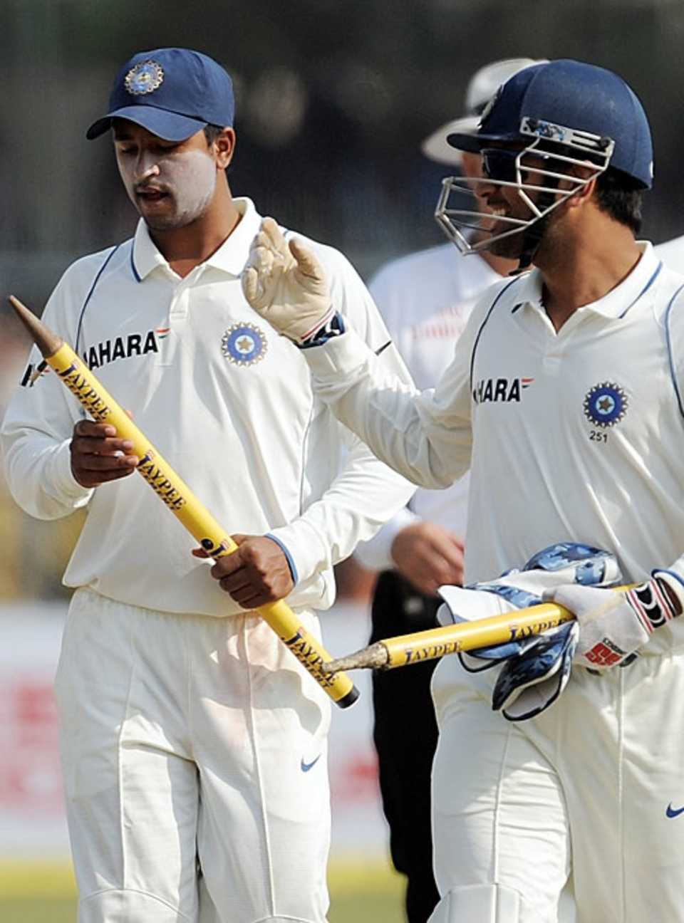 Pragyan Ojha gets the congratulations from MS Dhoni as India walk off victorious